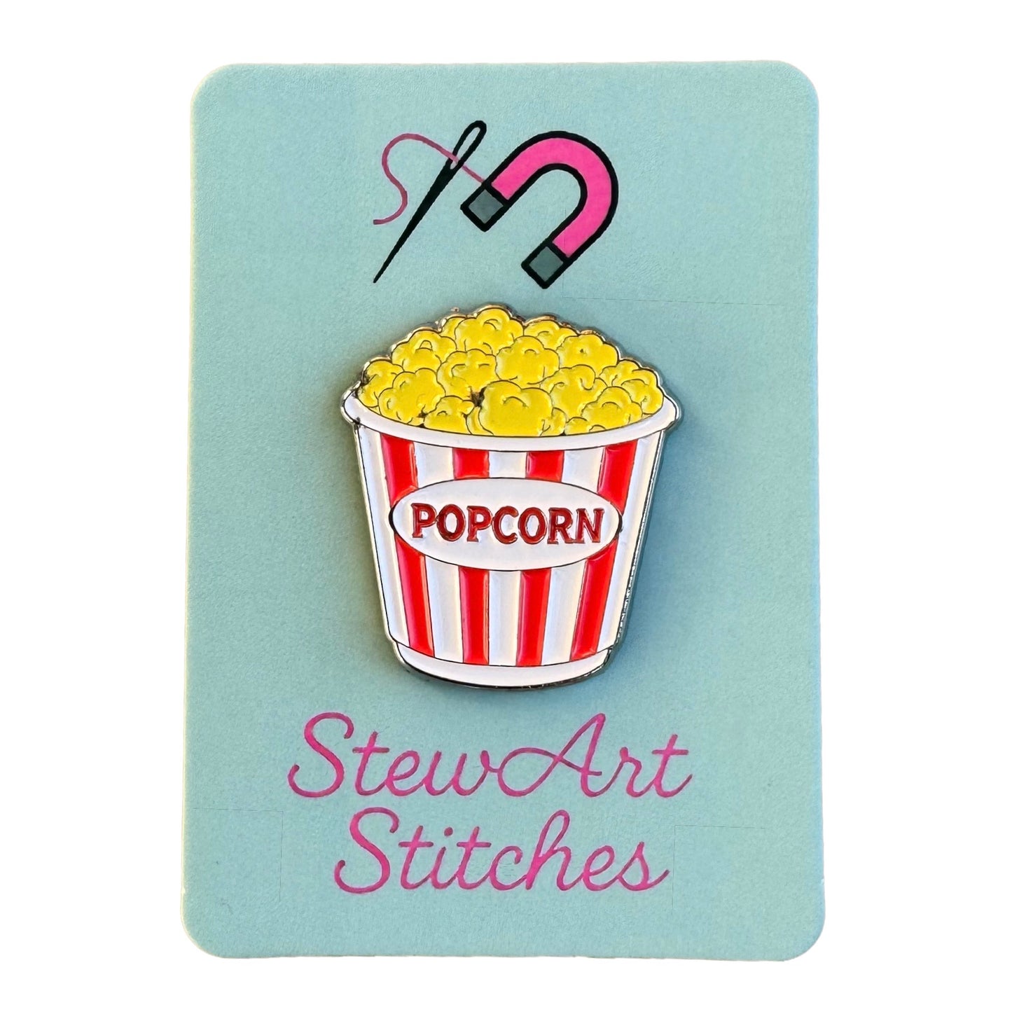 Popcorn enamel needle minder displayed on product packaging card for StewArt Stitches.