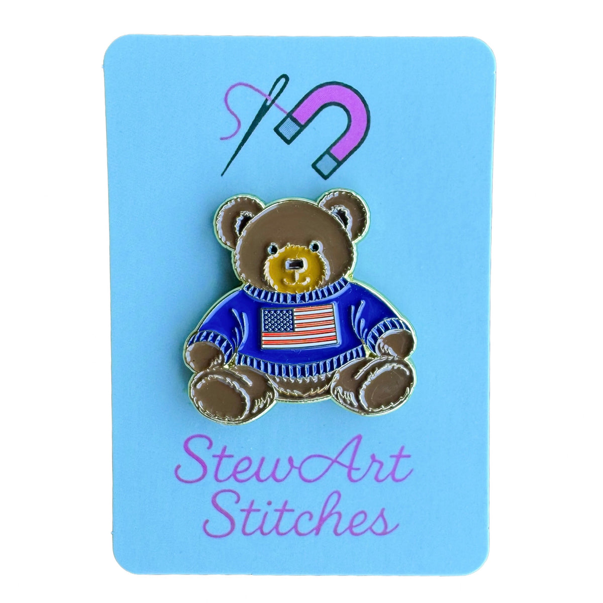 Teddy bear enamel needle minder wearing a blue sweater with an American flag, magnetic needle holder for cross stitch, needlepoint, embroidery, quilting, sewing and other stitching projects.