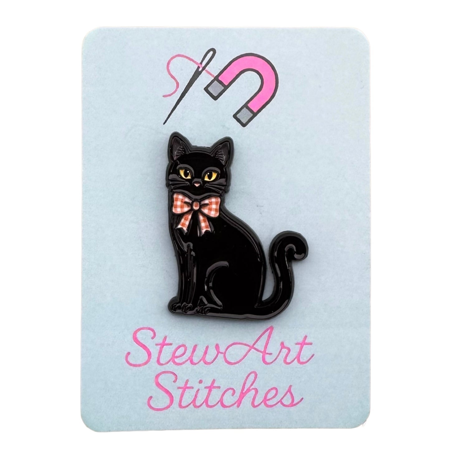 Black cat magnetic enamel needle minder displayed on product packaging card for StewArt Stitches.