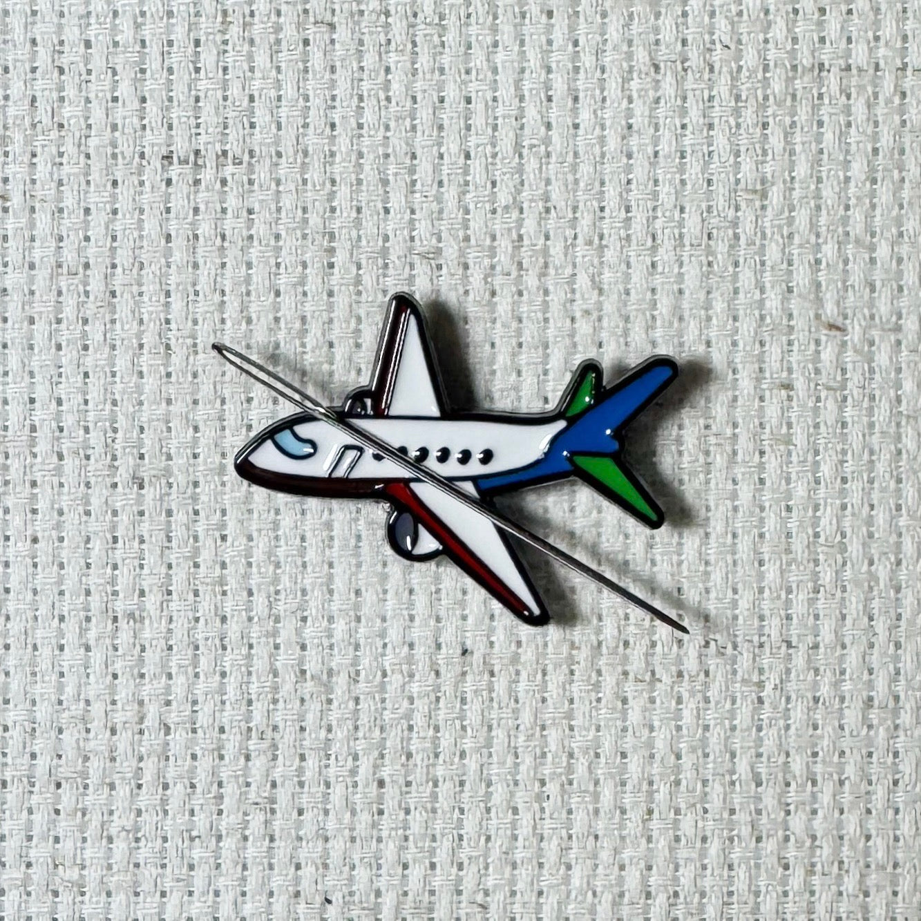 Airplane magnetic needle minder – travel themed enamel accessory for cross stitch, embroidery, and needlepoint – fun stitching gift for travelers and adventure lovers.