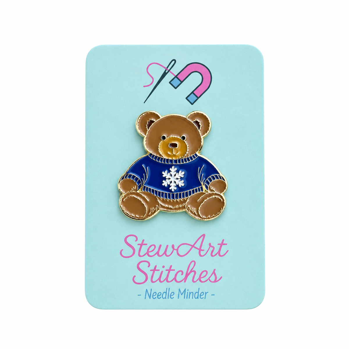 Teddy bear enamel needle minder wearing a blue sweater with a snowflake, magnetic needle holder for cross stitch, needlepoint, embroidery, quilting, sewing and other stitching projects.