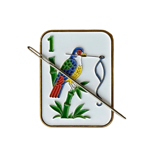 Birdie Bam mahjong tile needle minder featuring a colorful bird design enamel needle minder with gold color trim, magnetic accessory for cross stitch, needlepoint, embroidery, quilting and sewing.
