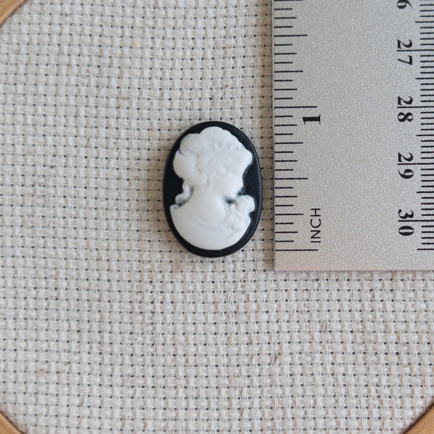 Vintage inspired black and white cameo resin needle minder for cross stitch, needlepoint and embroidery, antique-style stitching accessory, unique resin needle minder for craft lovers, elegant sewing tool gift.