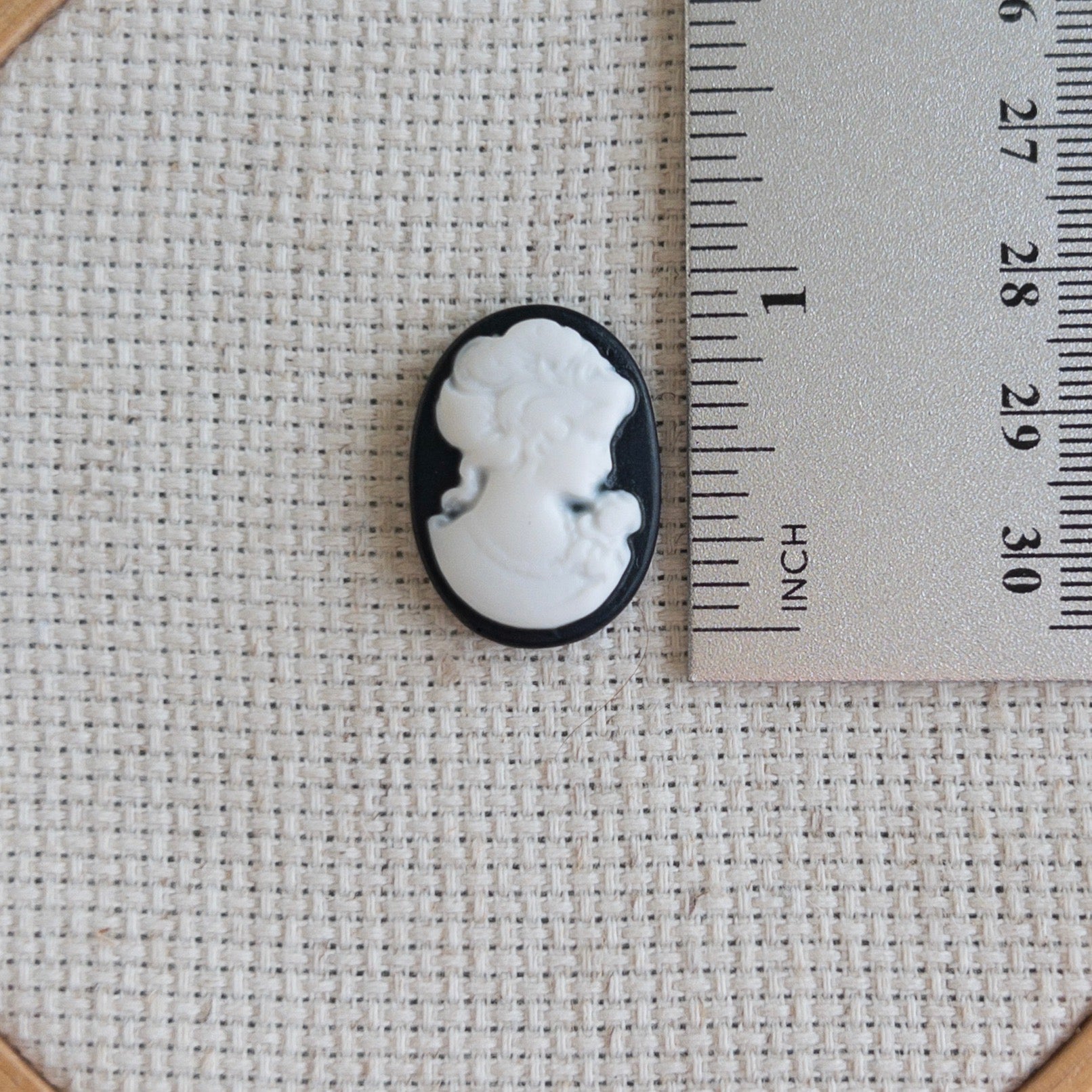 Vintage inspired black and white cameo resin needle minder for cross stitch, needlepoint and embroidery, antique-style stitching accessory, unique resin needle minder for craft lovers, elegant sewing tool gift.