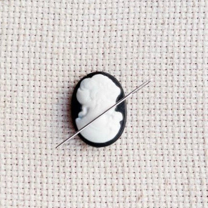 Vintage inspired black and white cameo resin needle minder for cross stitch, needlepoint and embroidery, antique-style stitching accessory, unique resin needle minder for craft lovers, elegant sewing tool gift.