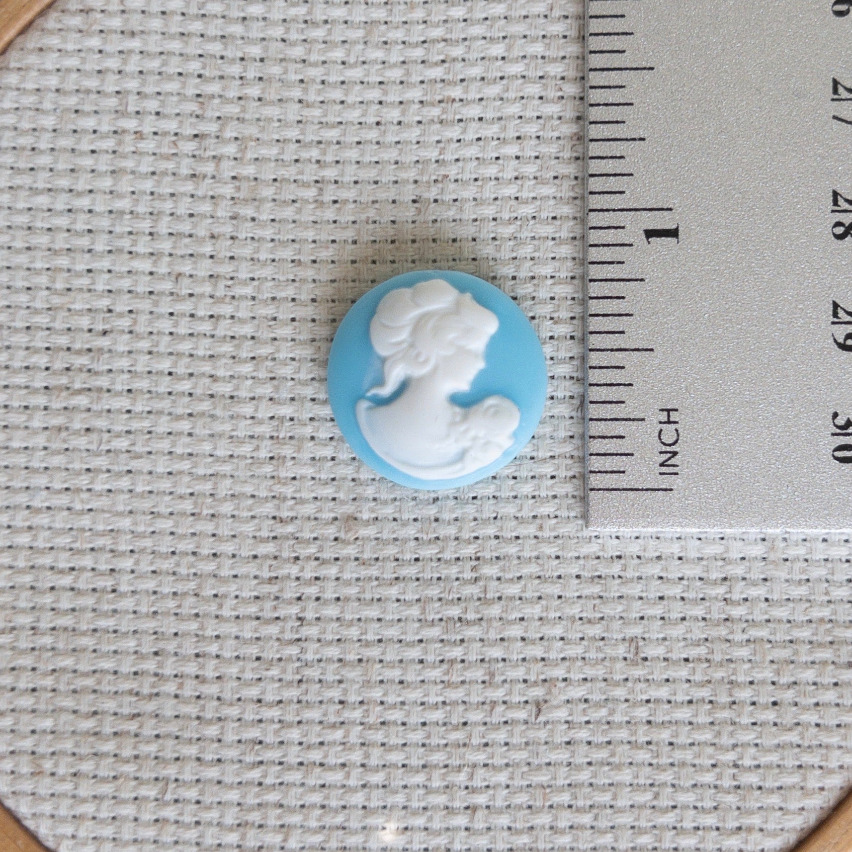 Vintage inspired blue and white cameo resin needle minder for cross stitch, needlepoint and embroidery, antique-style stitching accessory, unique resin needle minder for craft lovers, elegant sewing tool gift.