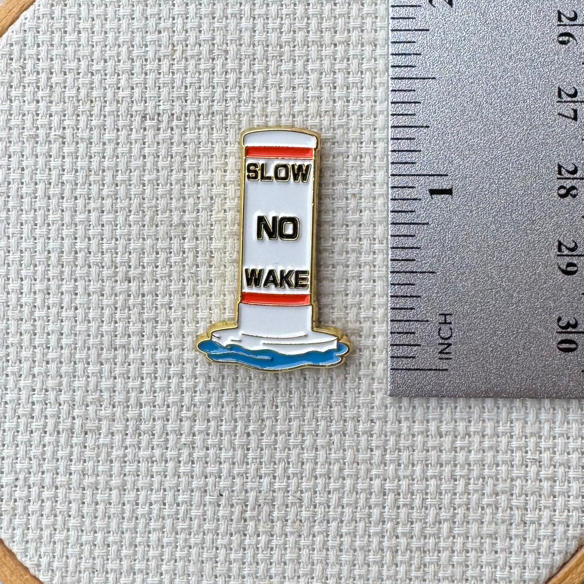 Buoy needle minder shown with ruler for size measurement, approximately 1.25 inch.