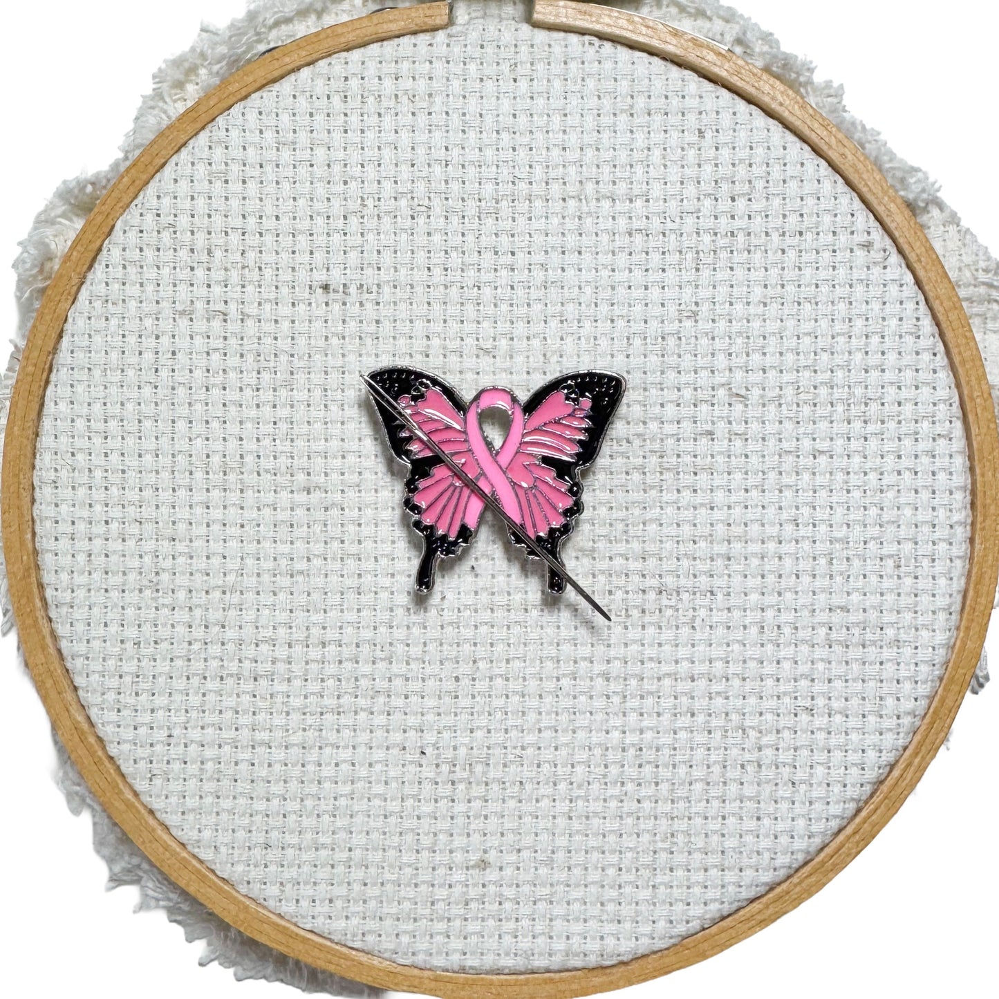Butterfly Pink Ribbon magnetic enamel needle minder – a meaningful needle holder for cross stitch, embroidery, sewing, quilting, or needlepoint. Show your support and raise breast cancer awareness with every stitch.