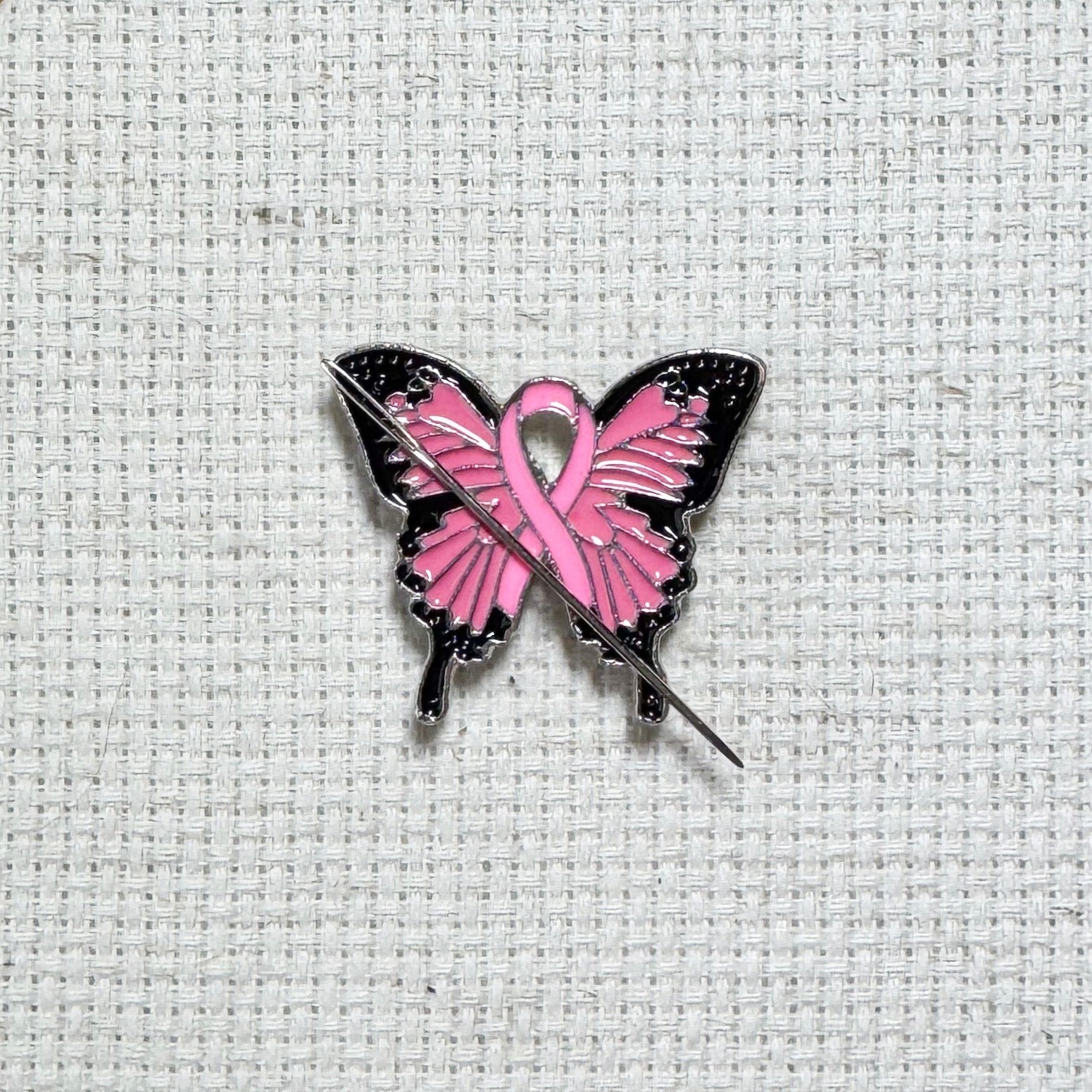 Butterfly Pink Ribbon magnetic enamel needle minder – a meaningful needle holder for cross stitch, embroidery, sewing, quilting, or needlepoint. Show your support and raise breast cancer awareness with every stitch.