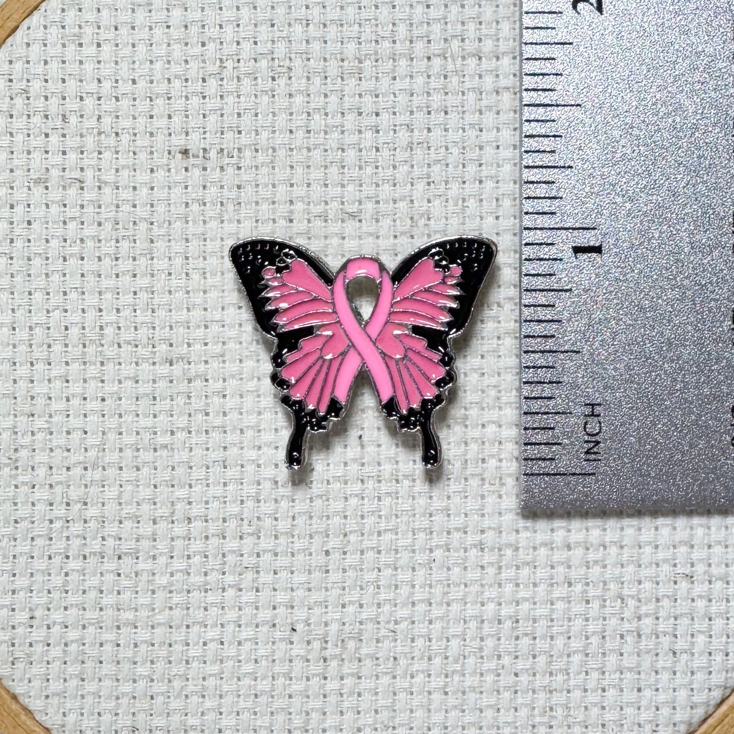 Butterfly Pink Ribbon magnetic enamel needle minder – a meaningful needle holder for cross stitch, embroidery, sewing, quilting, or needlepoint. Show your support and raise breast cancer awareness with every stitch.