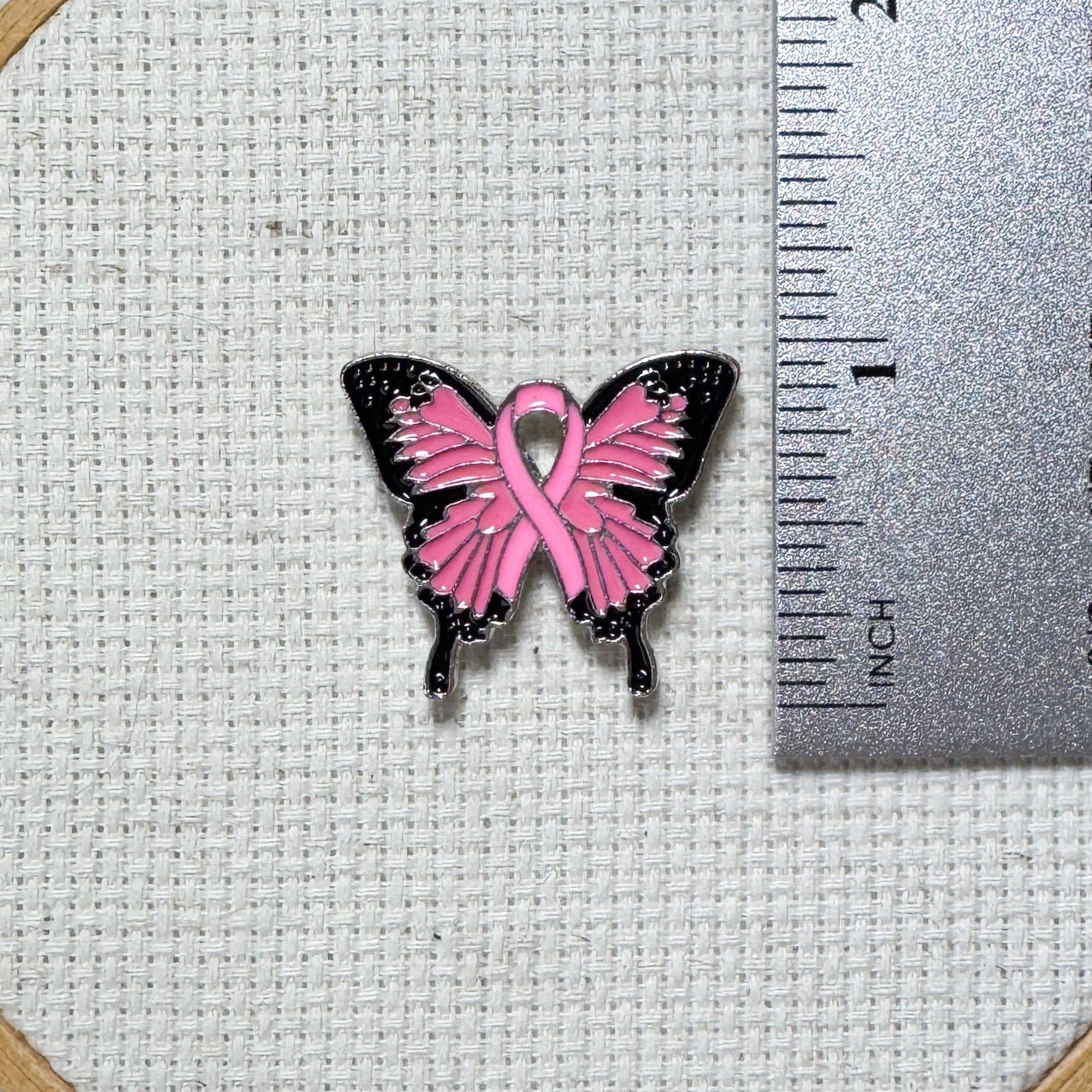 Butterfly Pink Ribbon magnetic enamel needle minder – a meaningful needle holder for cross stitch, embroidery, sewing, quilting, or needlepoint. Show your support and raise breast cancer awareness with every stitch.