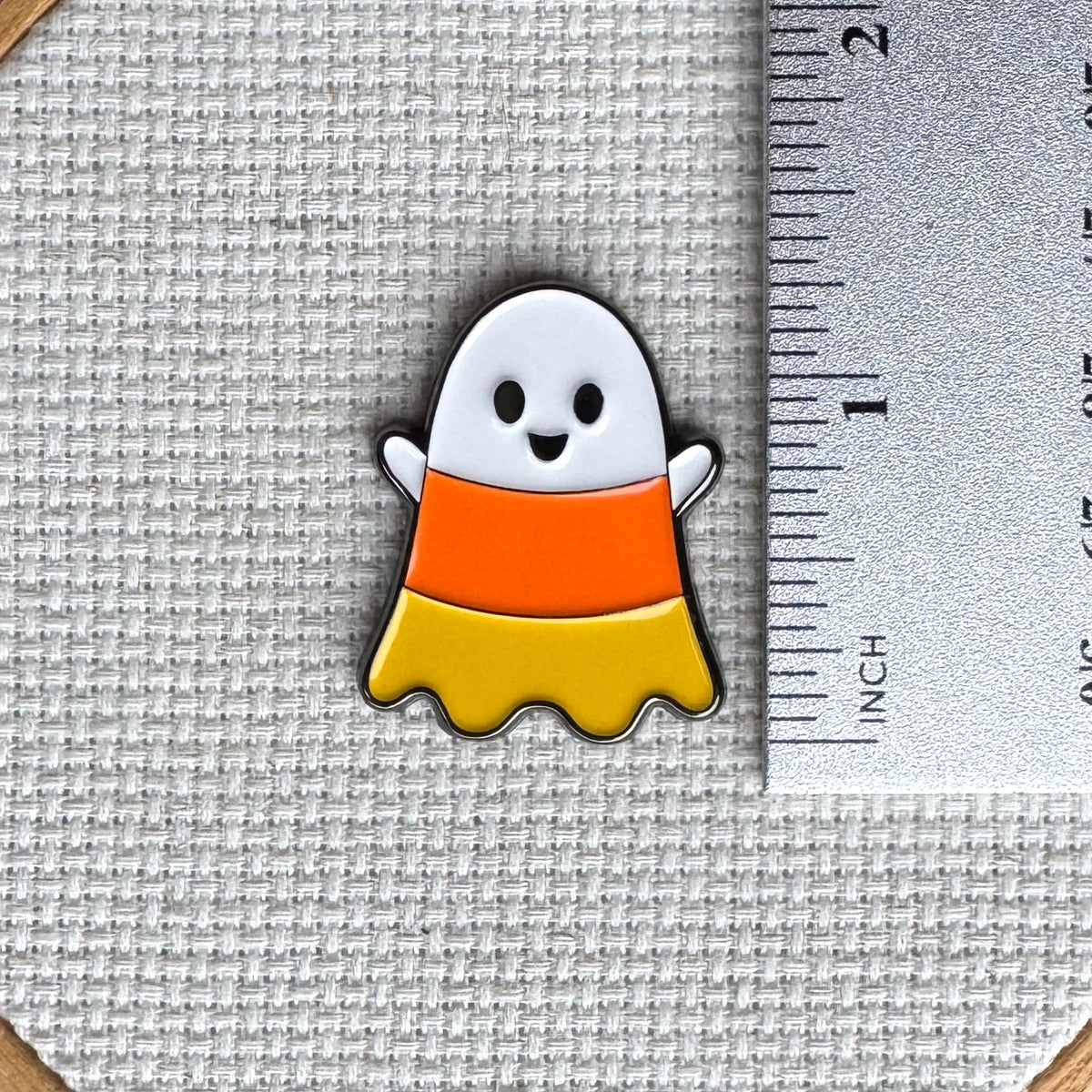 Candy corn ghost magnetic needle minder by StewArt Stitches, enamel Halloween needlework accessory for cross stitch, needlepoint and embroidery.