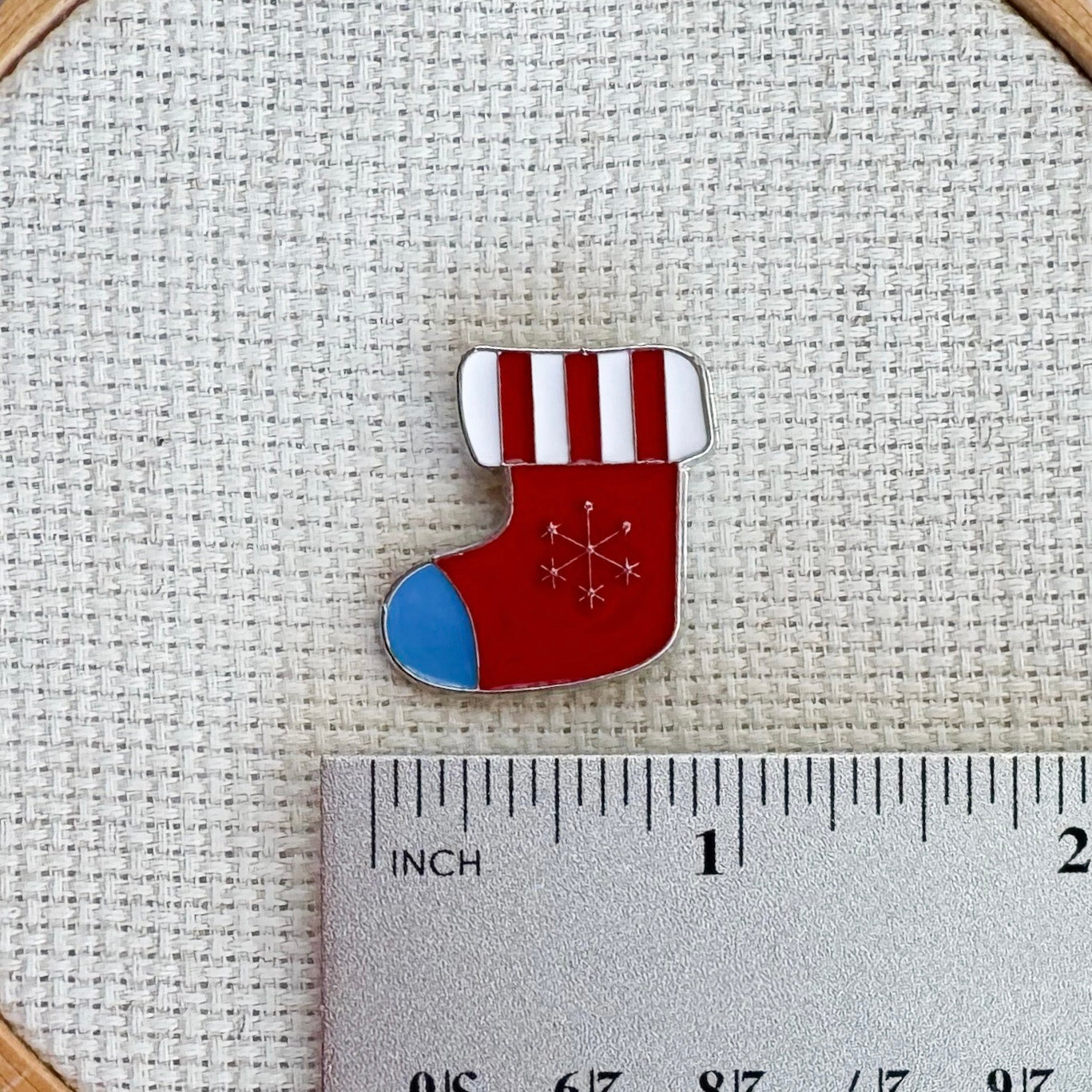 Christmas stocking magnetic needle minder – festive enamel accessory for cross stitch, embroidery, and needlepoint – holiday stitching gift with classic stocking design.