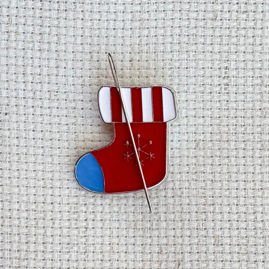 Christmas stocking magnetic needle minder – festive enamel accessory for cross stitch, embroidery, and needlepoint – holiday stitching gift with classic stocking design.