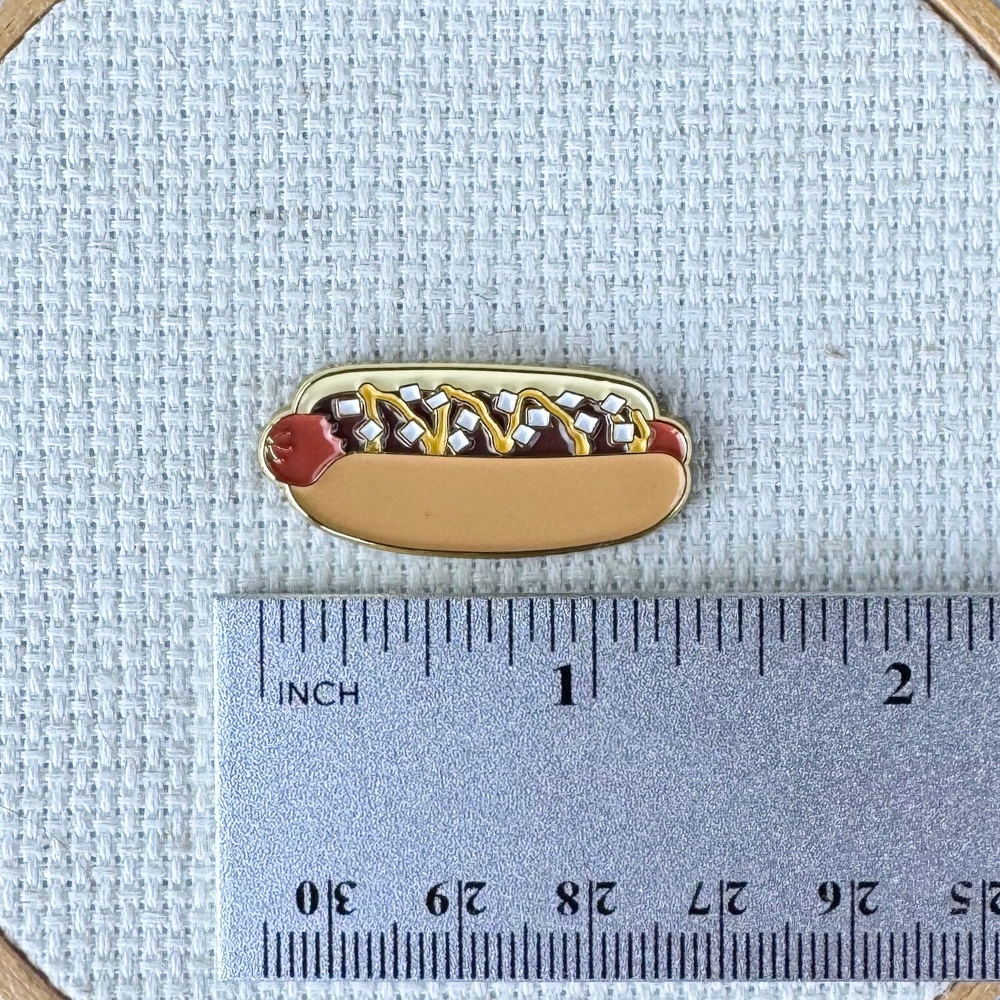 Coney Island hot dog magnetic enamel needle minder inspired by the iconic American hot dog, perfect for cross stitch, needlepoint, embroidery, quilting and sewing.