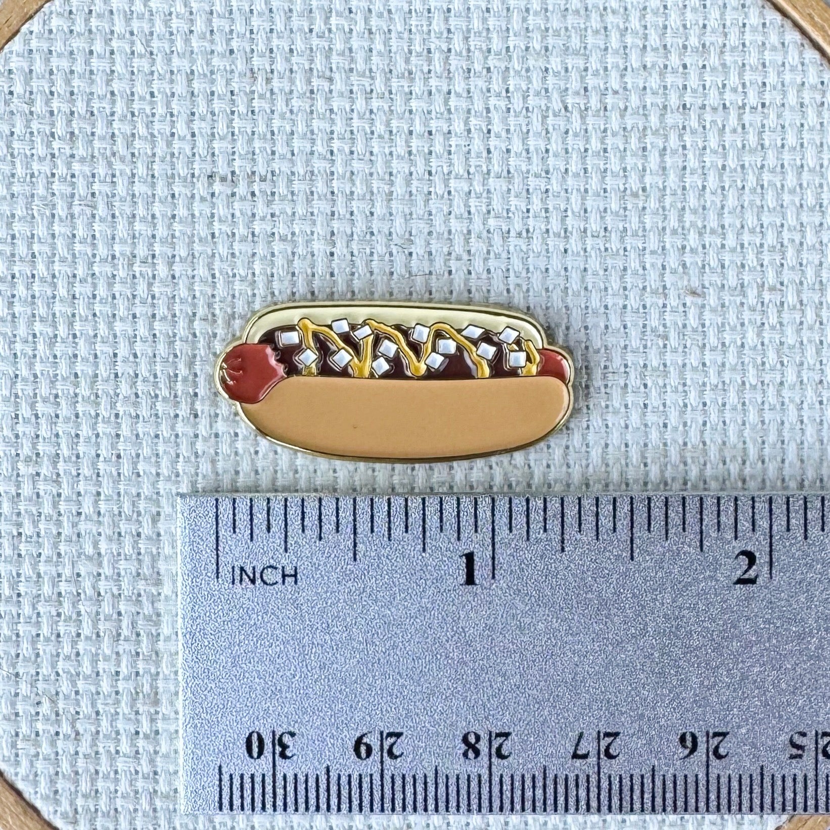 Coney Island hot dog magnetic enamel needle minder inspired by the iconic American hot dog, perfect for cross stitch, needlepoint, embroidery, quilting and sewing.