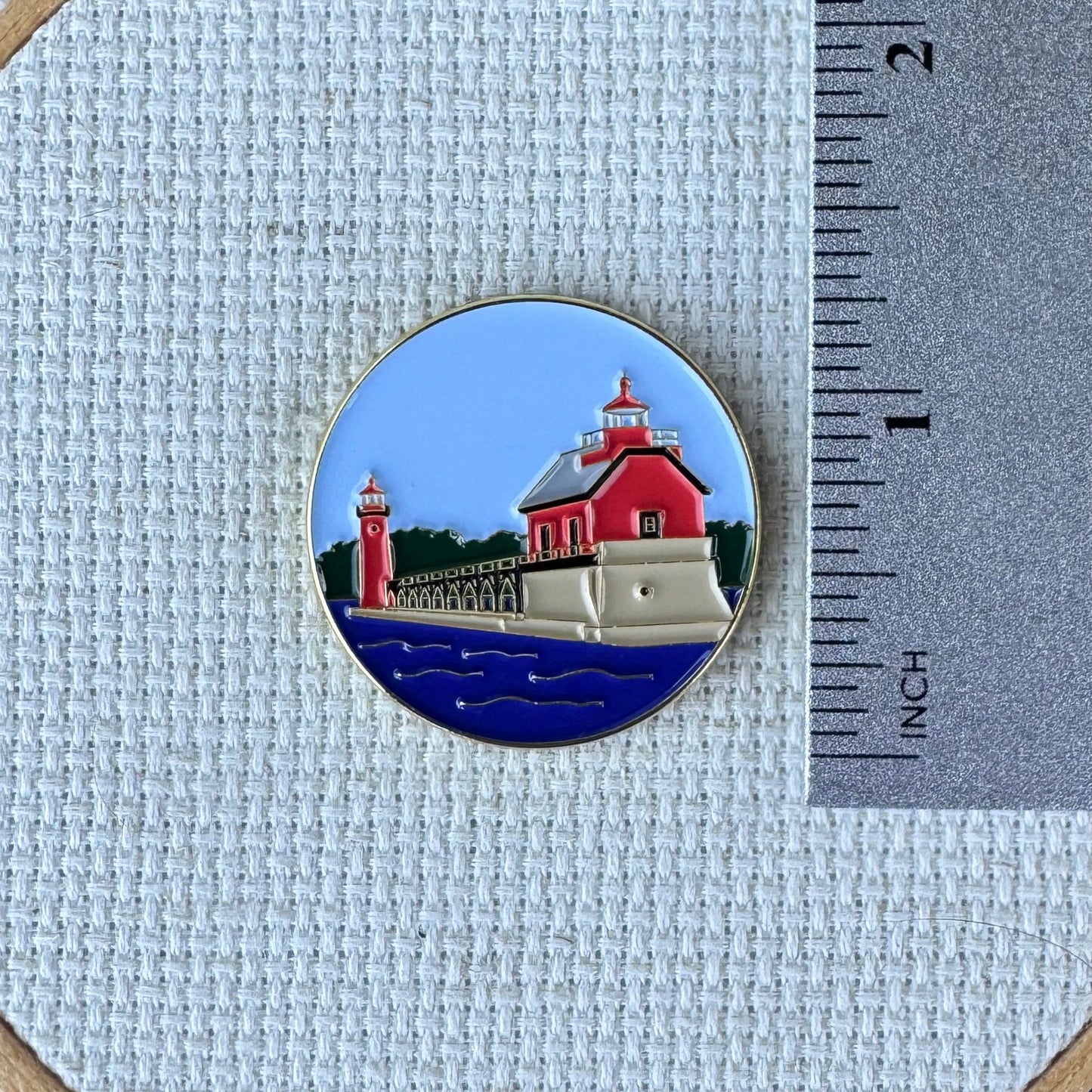 Grand Haven Lighthouse enamel needle minder inspired by the iconic red lighthouses on Lake Michigan, magnetic accessory for cross stitch, needlepoint, embroidery, quilting and sewing.