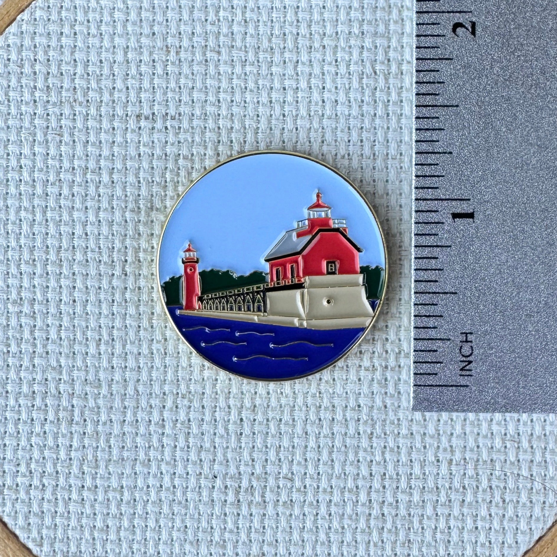 Grand Haven Lighthouse enamel needle minder inspired by the iconic red lighthouses on Lake Michigan, magnetic accessory for cross stitch, needlepoint, embroidery, quilting and sewing.