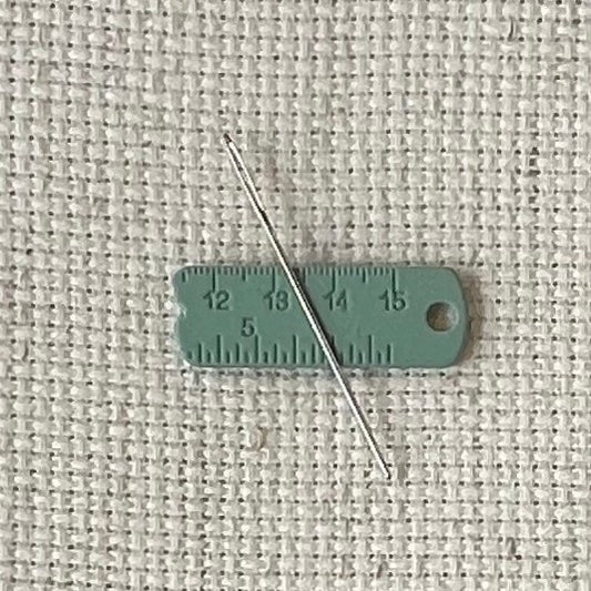 Green enamel measuring tape needle minder for cross stitch, embroidery, quilting, needlepoint, crewel, tapestry, and sewing, magnetic stitching accessory, cute pink craft tool for knitters and crocheters, durable enamel needle minder gift.