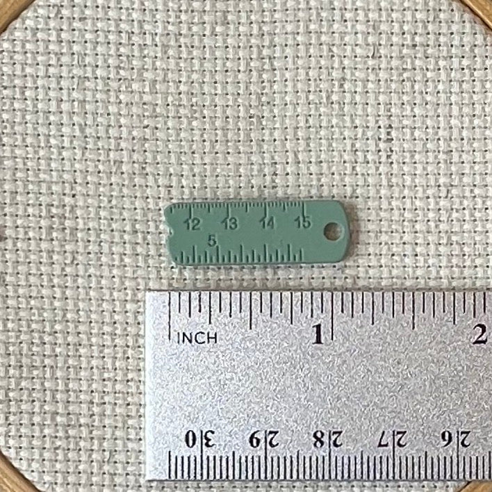 Green enamel measuring tape needle minder for cross stitch, embroidery, quilting, needlepoint, crewel, tapestry, and sewing, magnetic stitching accessory, cute pink craft tool for knitters and crocheters, durable enamel needle minder gift.