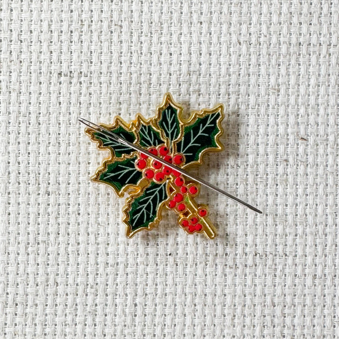 Holly Enamel Magnetic Needle Minder — add a festive floral touch to your cross stitch, embroidery, needlepoint, quilting, or hand sewing! A merry and bright needle holder for every Christmas stitcher and crafter.
