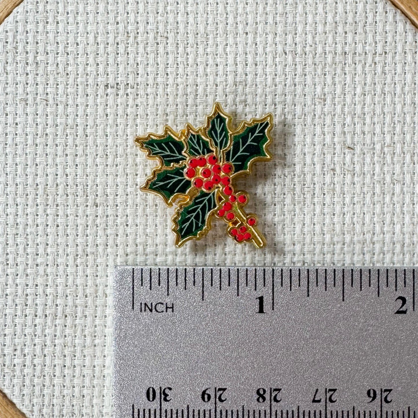 Holly Enamel Magnetic Needle Minder — add a festive floral touch to your cross stitch, embroidery, needlepoint, quilting, or hand sewing! A merry and bright needle holder for every Christmas stitcher and crafter.