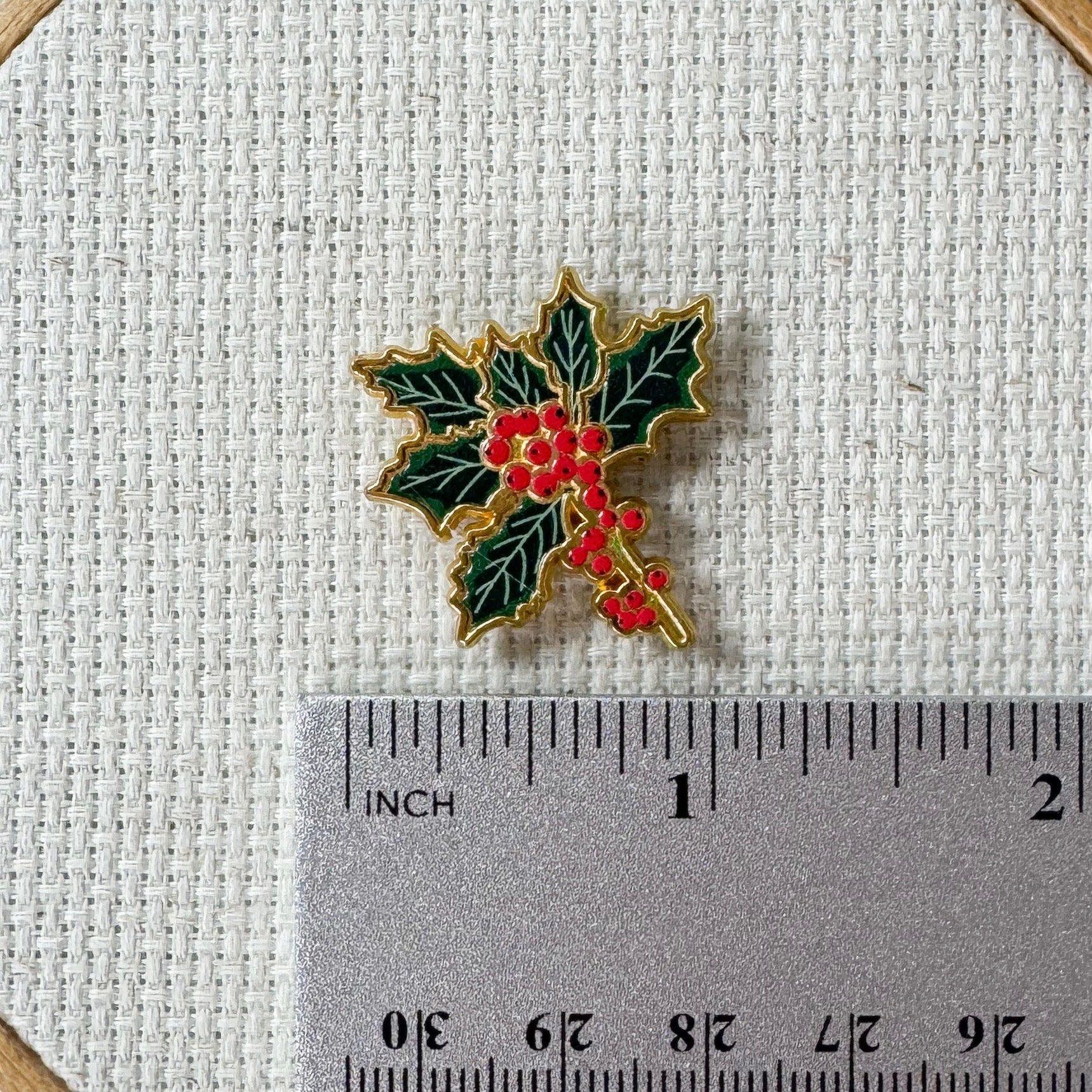 Holly Enamel Magnetic Needle Minder — add a festive floral touch to your cross stitch, embroidery, needlepoint, quilting, or hand sewing! A merry and bright needle holder for every Christmas stitcher and crafter.