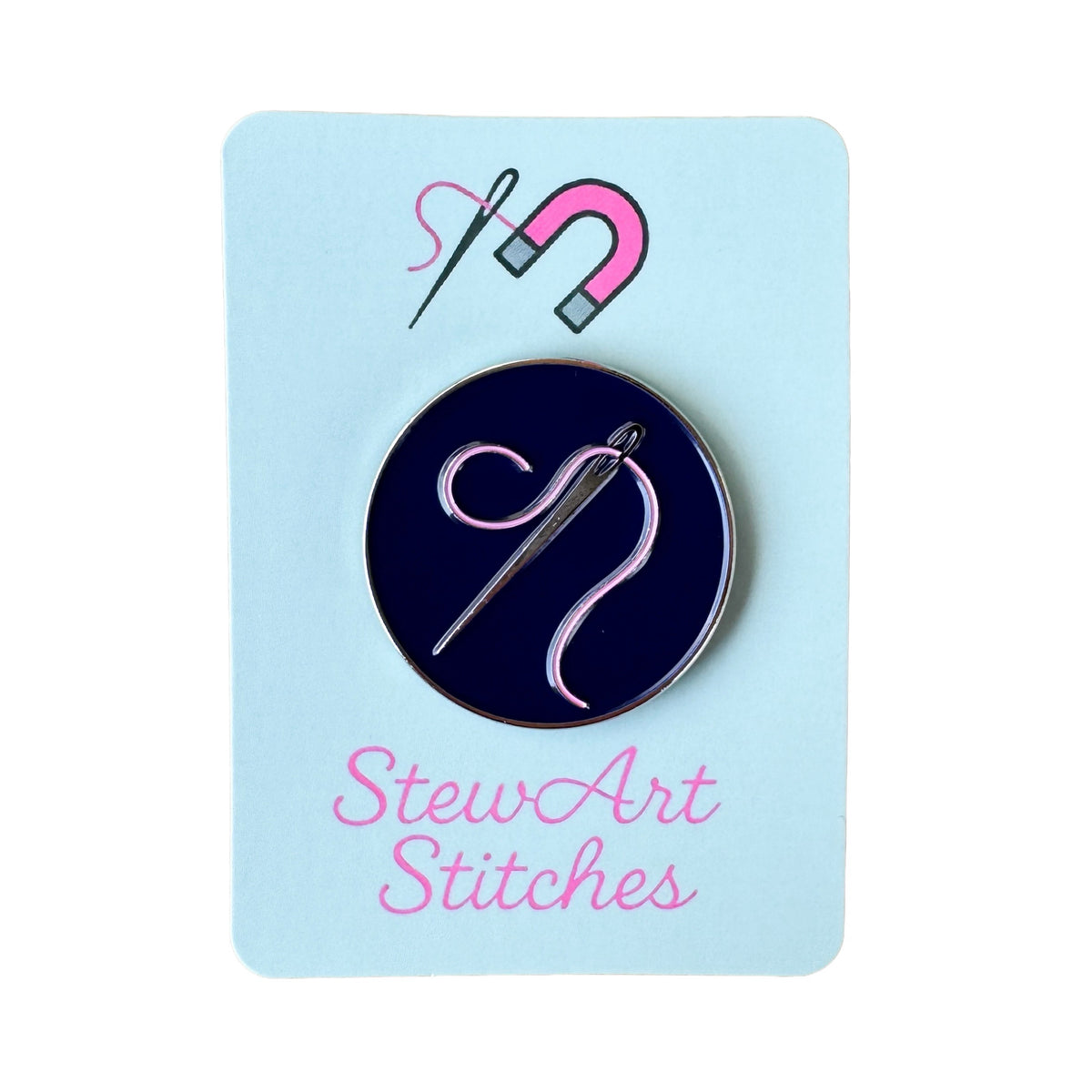 Needle and pink thread needle minder displayed on product packaging card for StewArt Stitches.
