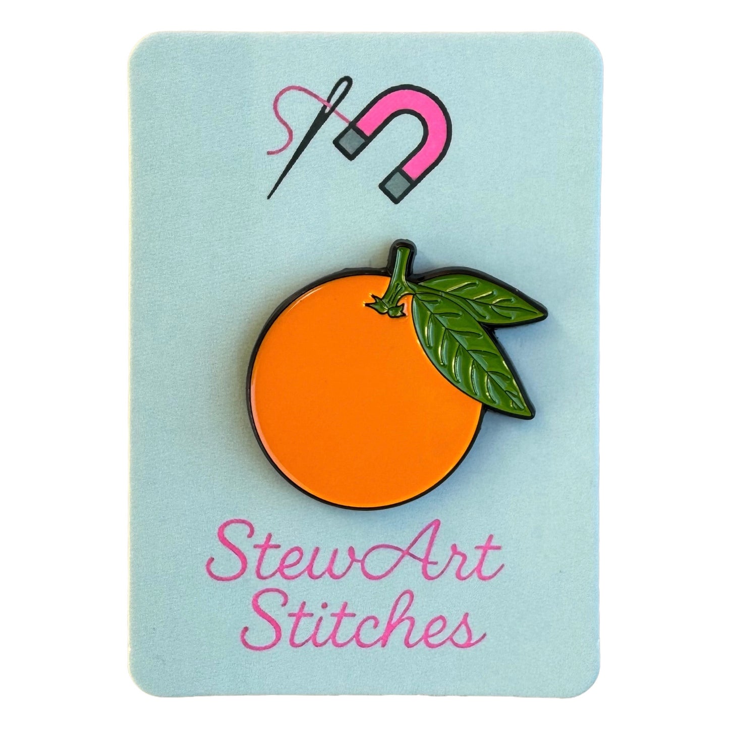 Orange magnetic enamel needle minder displayed on product packaging card for StewArt Stitches.