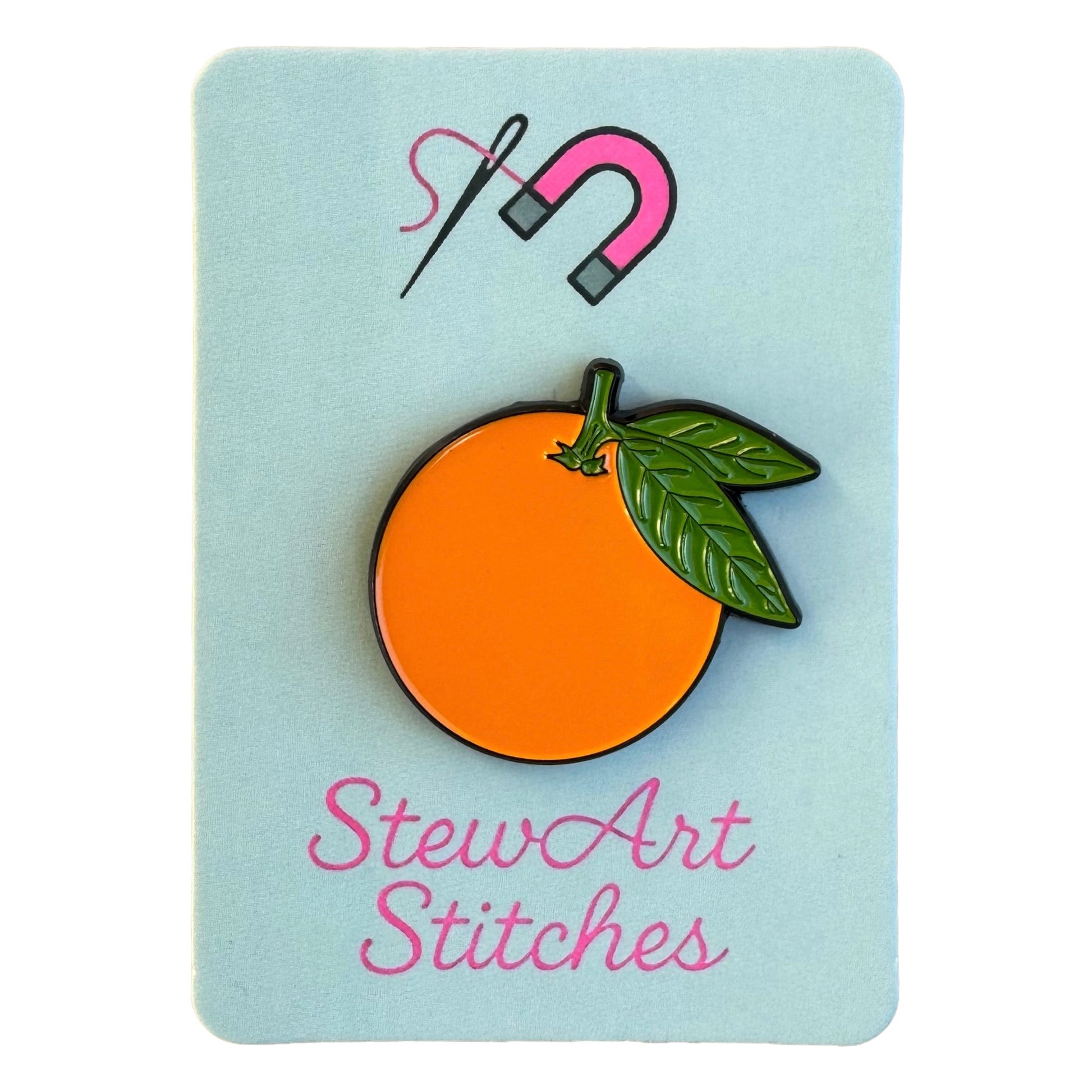 Orange magnetic enamel needle minder displayed on product packaging card for StewArt Stitches.