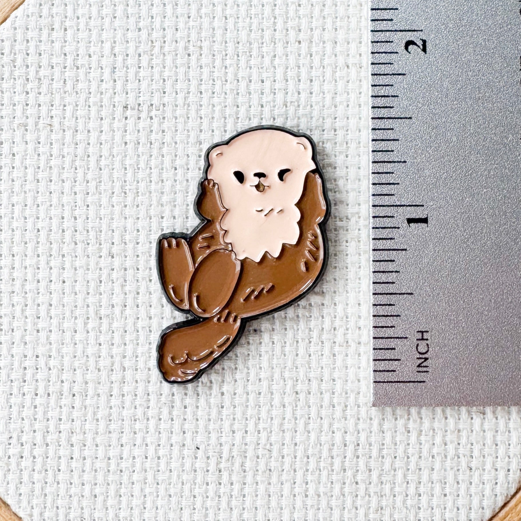 Brown otter magnetic needle minder – woodland animal enamel accessory for cross stitch, embroidery, and needlepoint – cute stitching gift for nature and wildlife lovers.