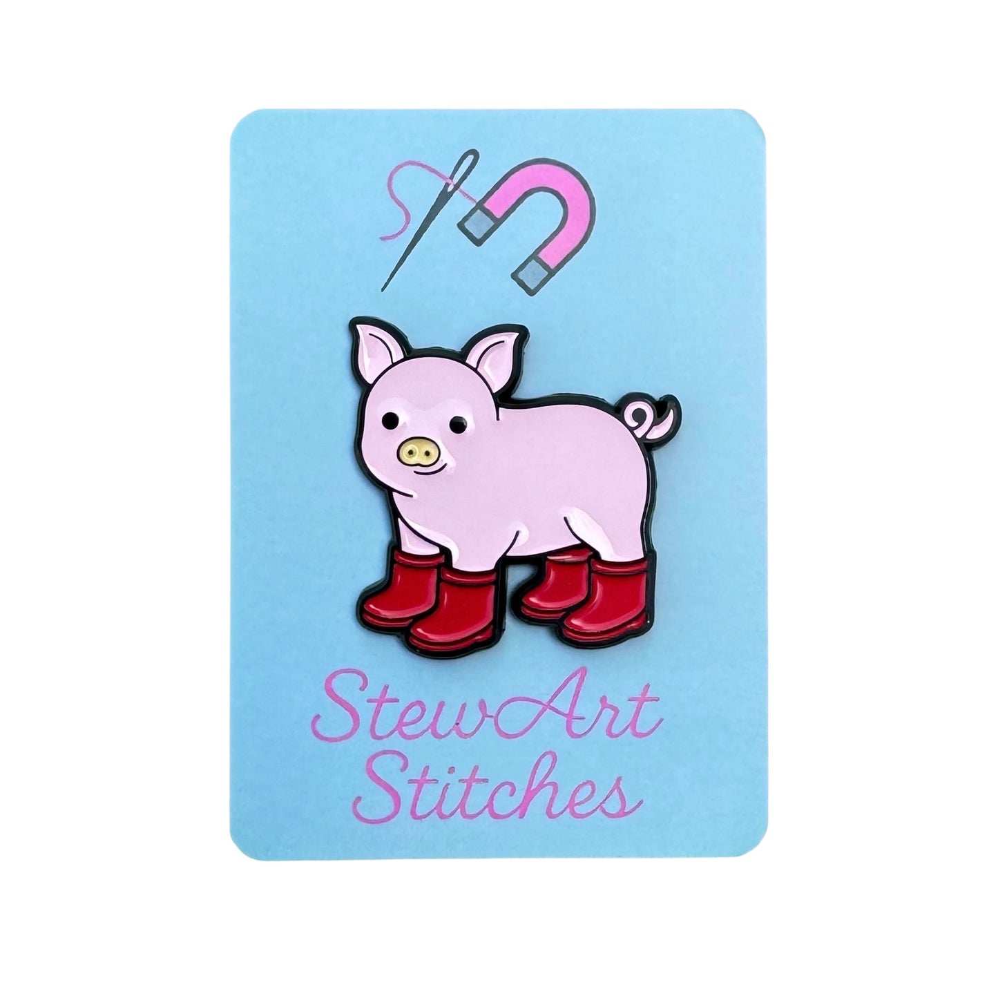 Pig with Red Boots Enamel Needle Minder magnetic enamel needle minder displayed on product packaging card for StewArt Stitches.