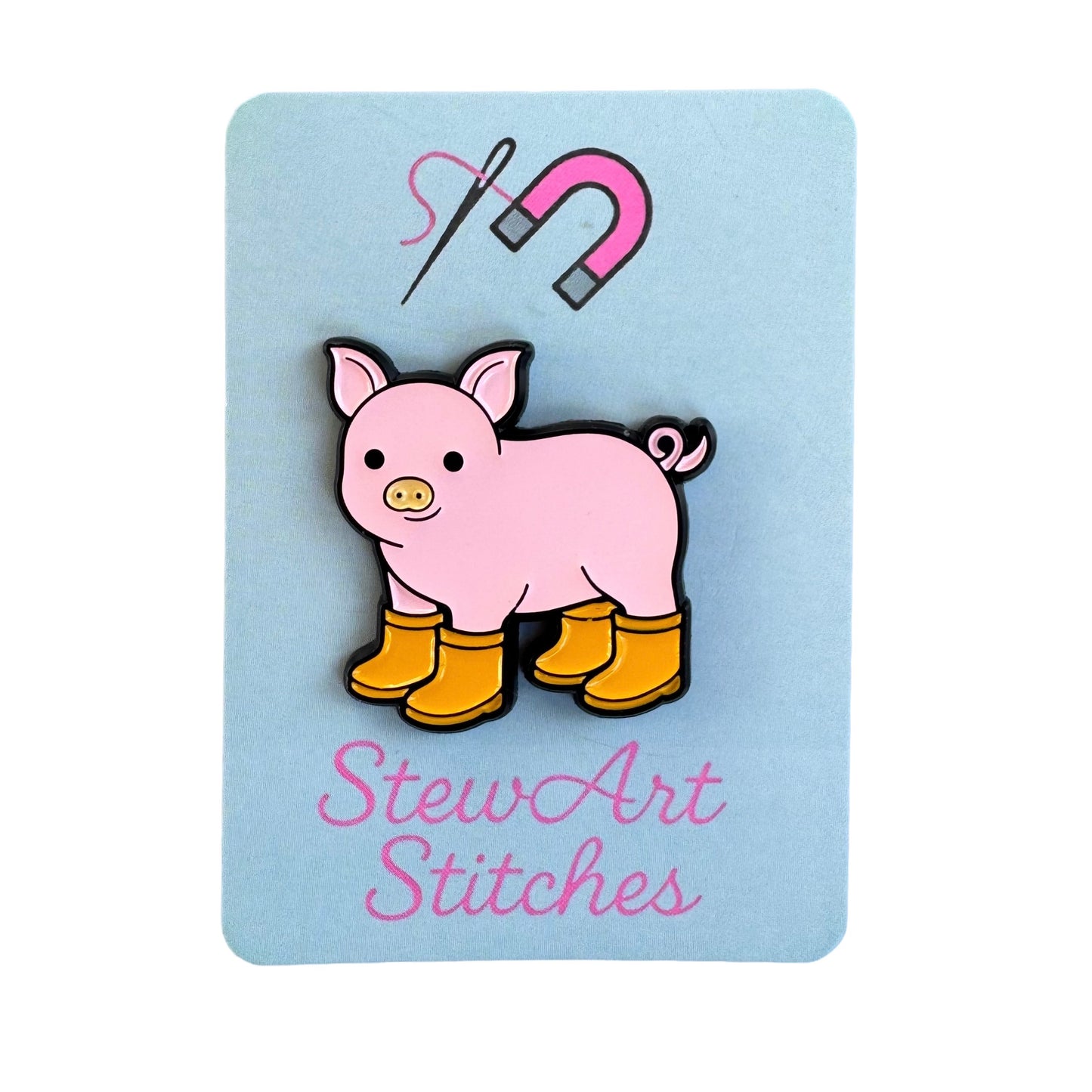 Pig with Yellow Boots Enamel magnetic enamel needle minder displayed on product packaging card for StewArt Stitches.
