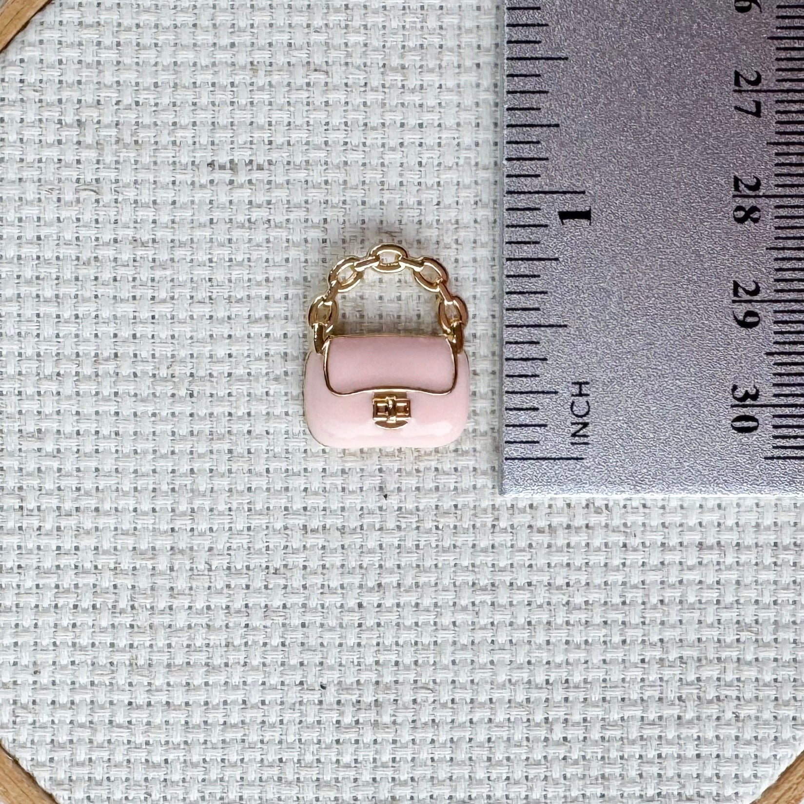 Pink purse magnetic needle minder – enamel accessory for cross stitch, embroidery, and needlepoint – stylish handbag design for fashion loving stitchers.