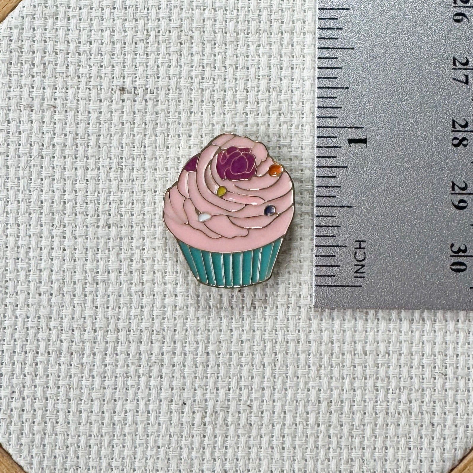 Pink cupcake magnetic needle minder – sweet enamel accessory for cross stitch, embroidery, and needlepoint – cute dessert themed stitching gift for bakers and cupcake lovers.