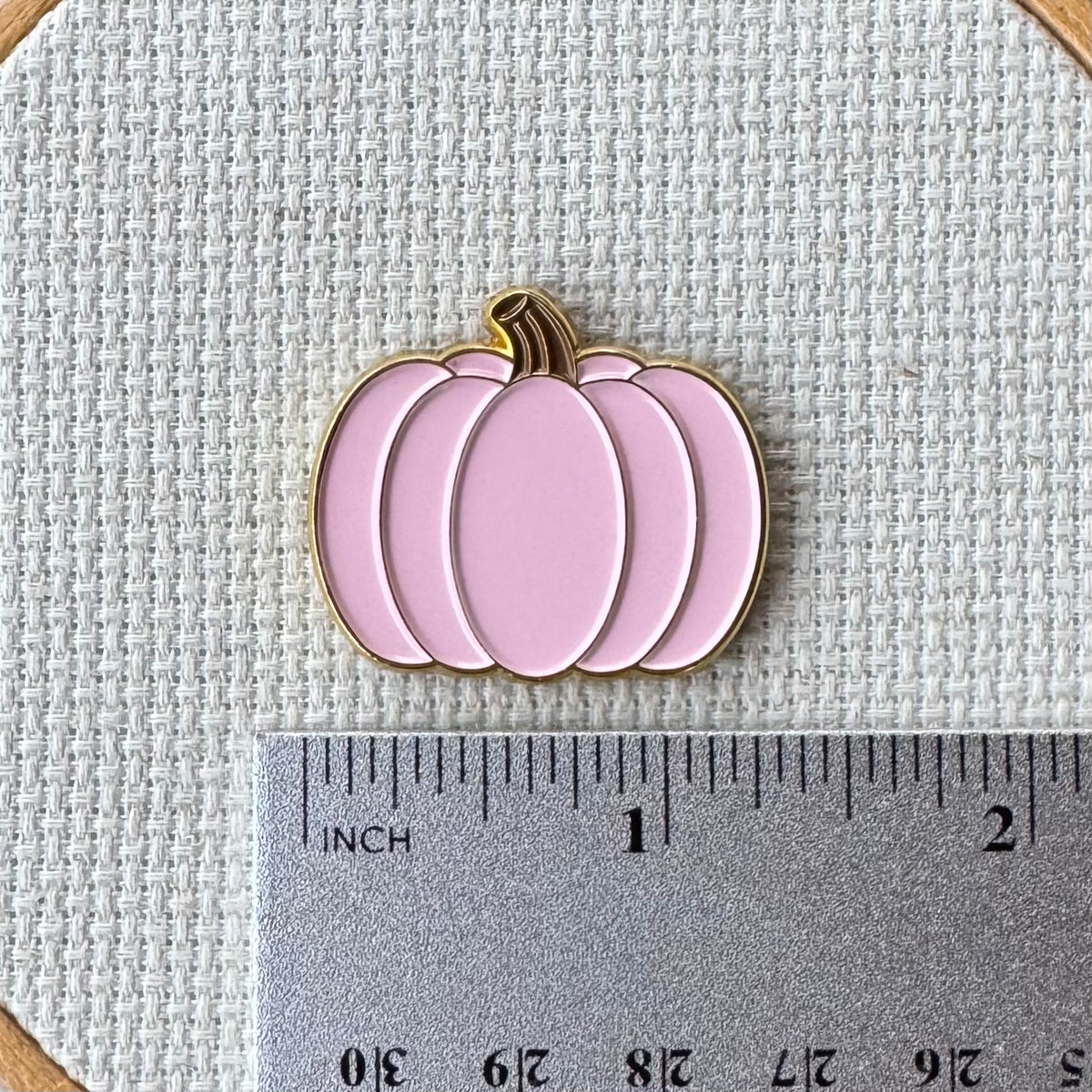 Pink pumpkin needle minder shown with ruler for size measurement, approximately 1.25 inch.