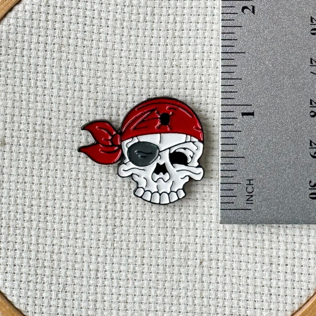 Pirate skull magnetic needle minder – enamel accessory for cross stitch, embroidery, and needlepoint – spooky nautical stitching gift for pirate lovers.