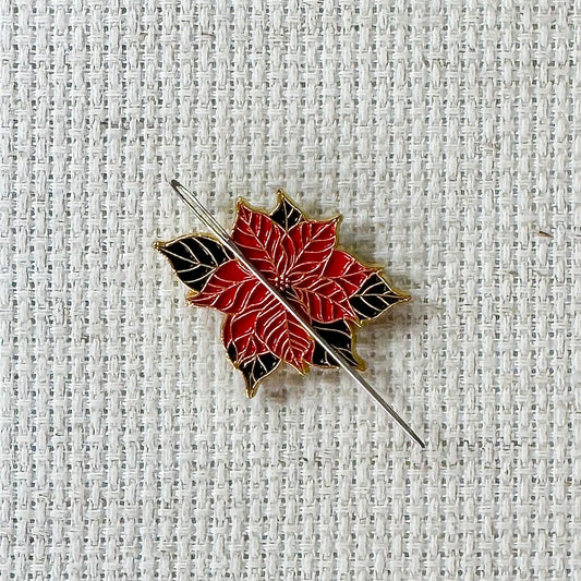 Poinsettia Enamel Magnetic Needle Minder — add a festive floral touch to your cross stitch, embroidery, needlepoint, quilting, or hand sewing! A merry and bright needle holder for every stitcher and crafter.
