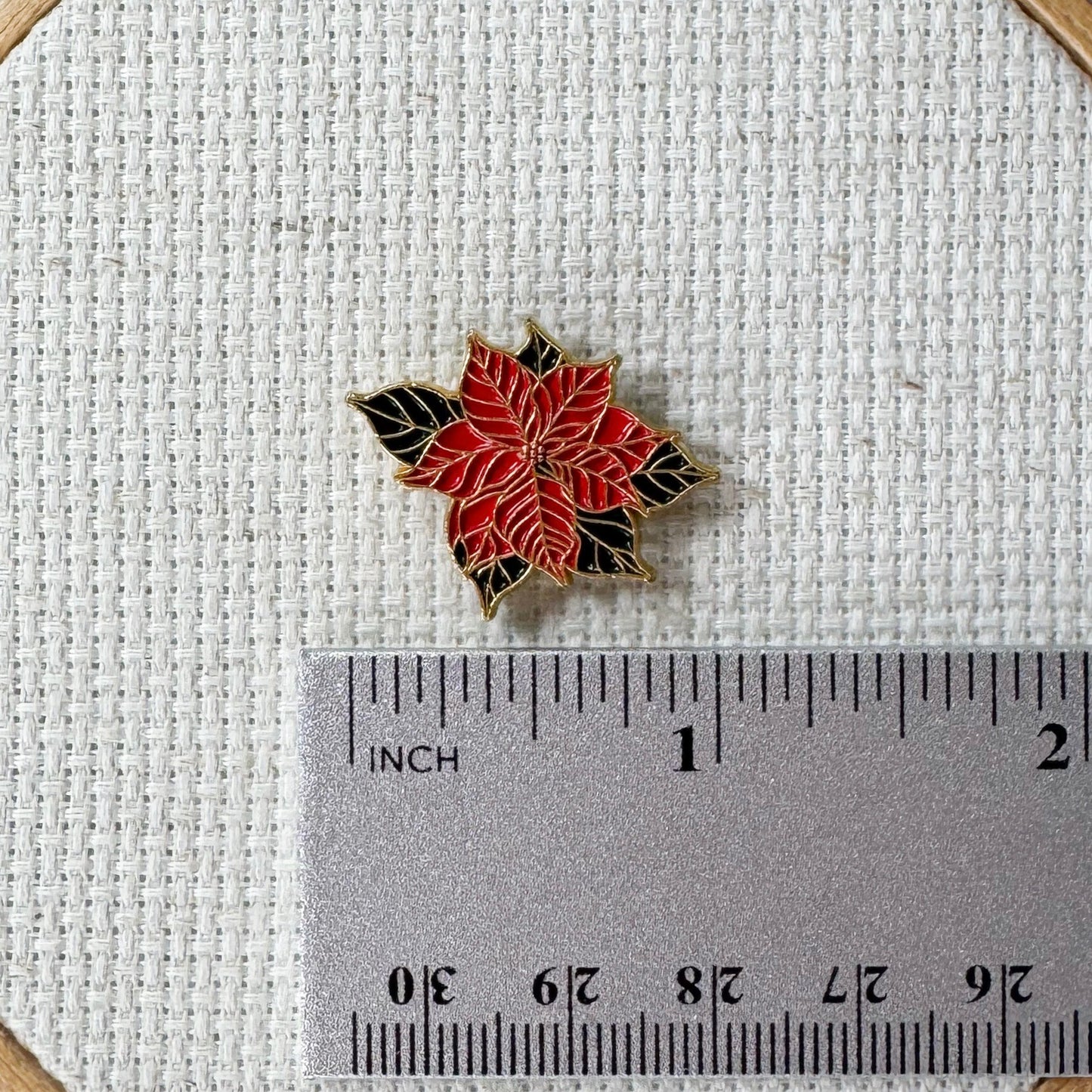 Poinsettia Enamel Magnetic Needle Minder — add a festive floral touch to your cross stitch, embroidery, needlepoint, quilting, or hand sewing! A merry and bright needle holder for every stitcher and crafter.