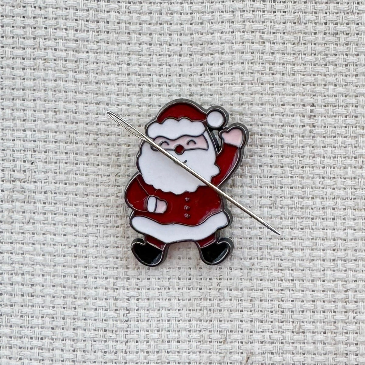 Santa Claus magnetic needle minder – jolly enamel accessory for cross stitch, embroidery, and needlepoint – festive Christmas stitching gift for holiday crafters.