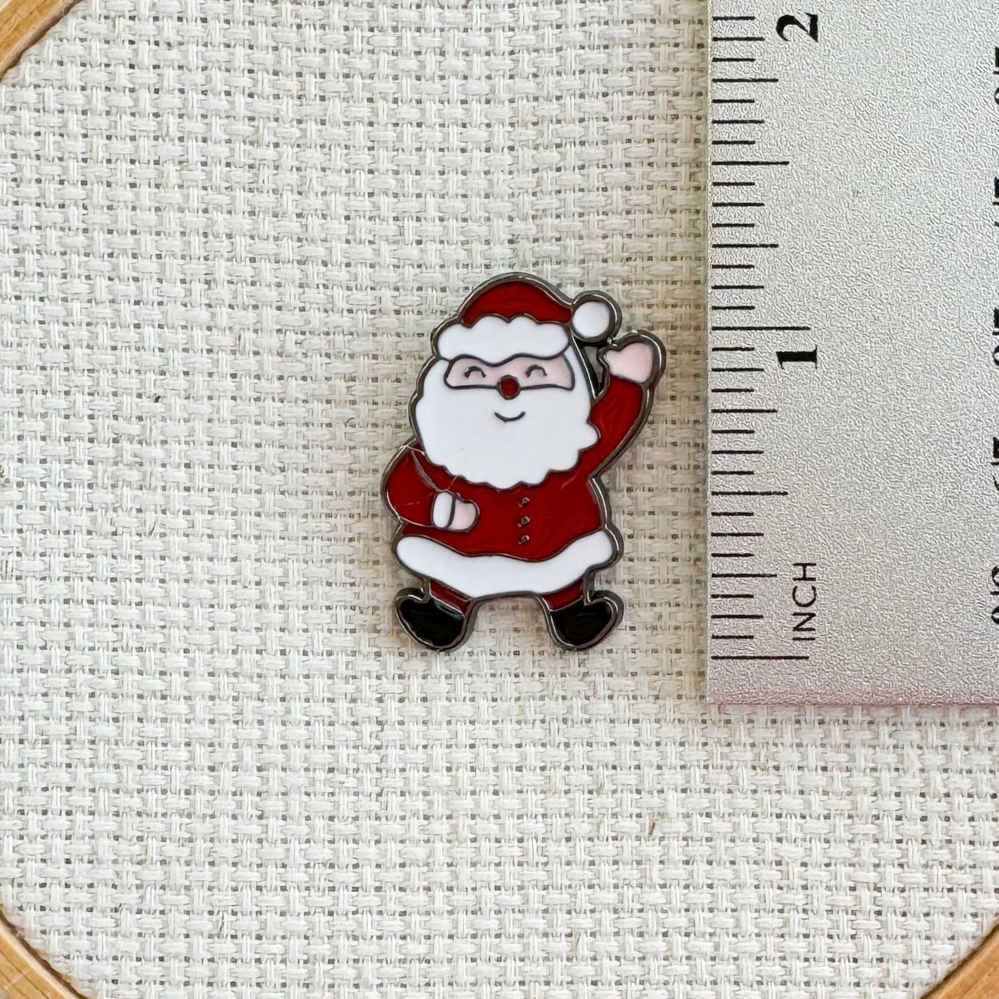 Santa Claus magnetic needle minder – jolly enamel accessory for cross stitch, embroidery, and needlepoint – festive Christmas stitching gift for holiday crafters.