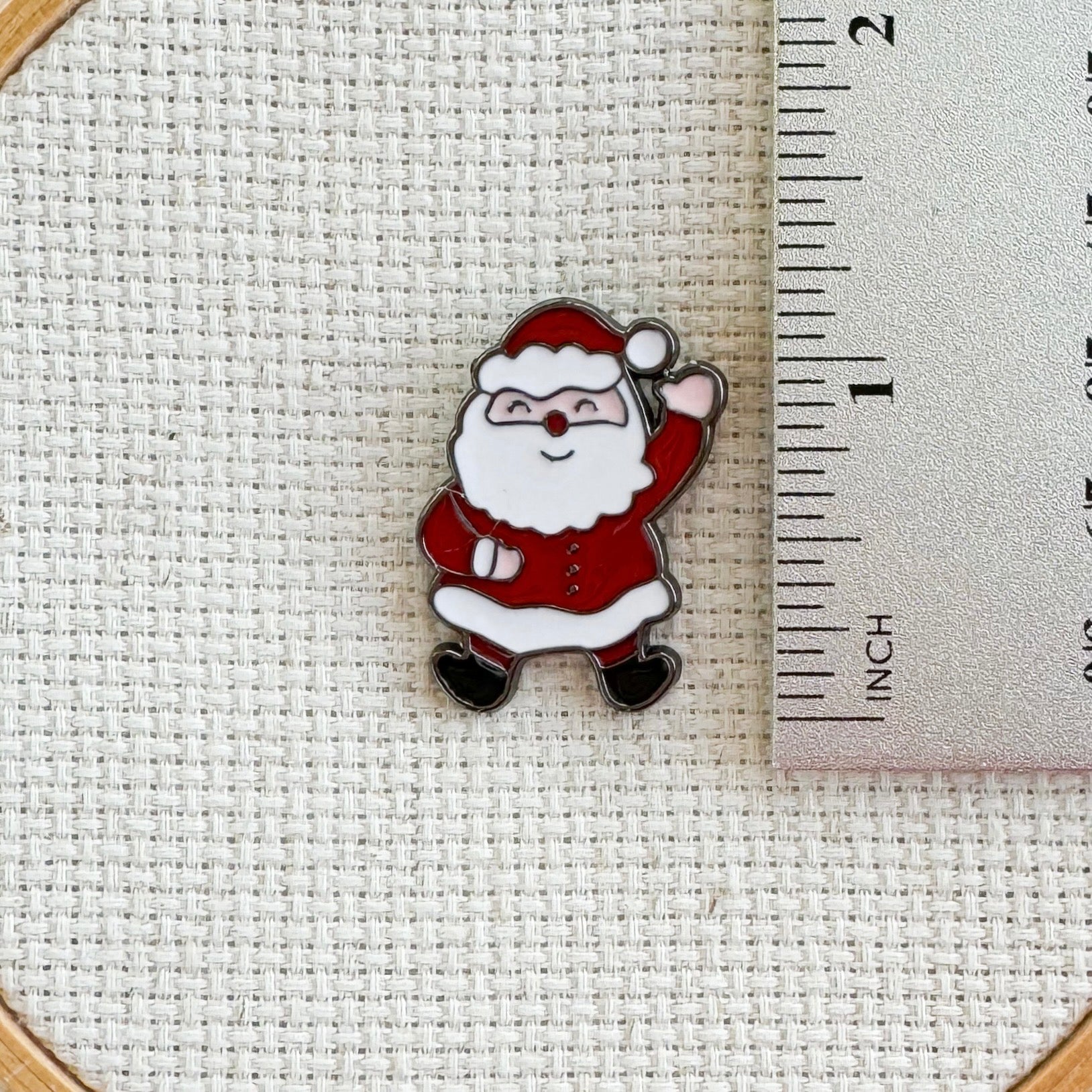 Santa Claus magnetic needle minder – jolly enamel accessory for cross stitch, embroidery, and needlepoint – festive Christmas stitching gift for holiday crafters.