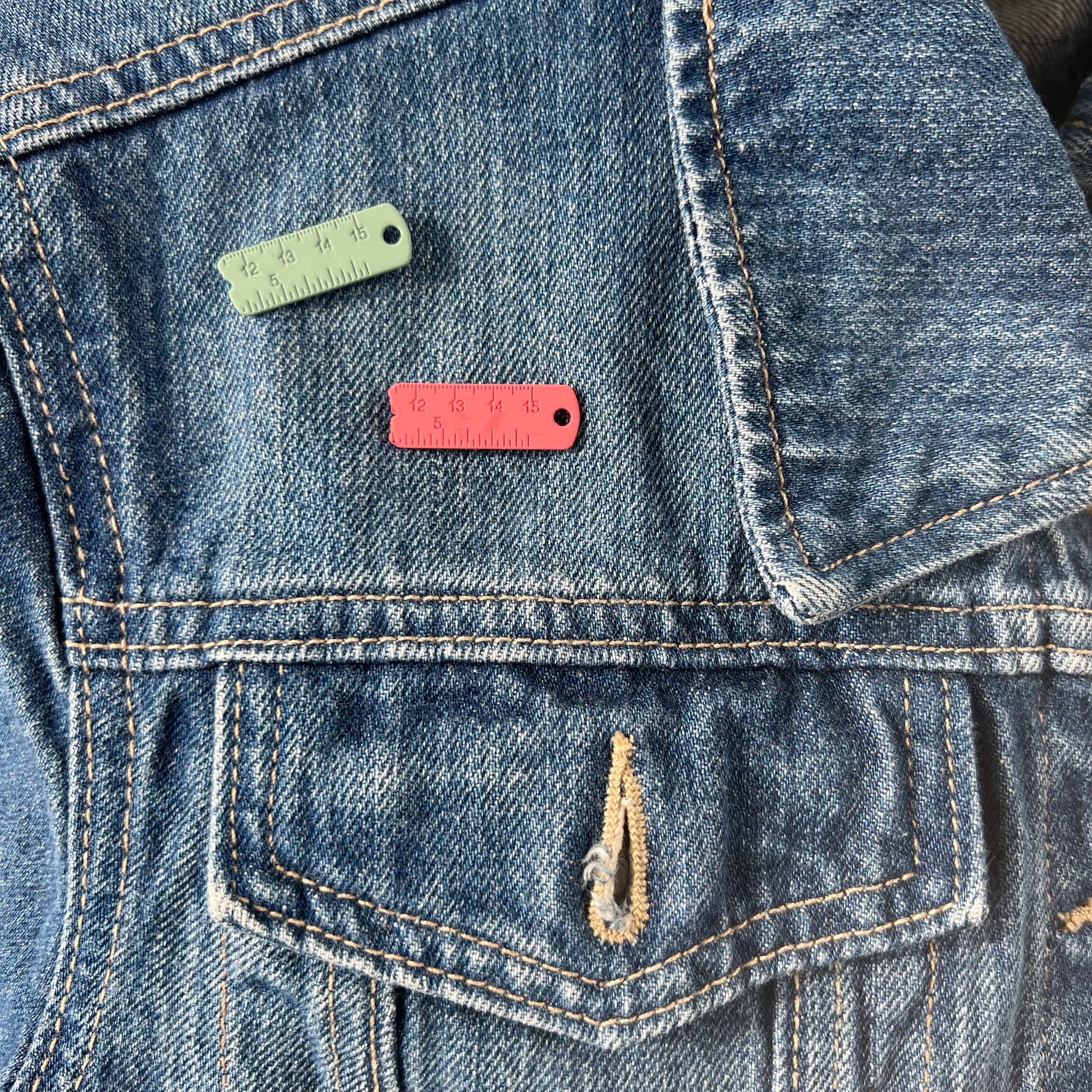 Set of 2 pink and green enamel measuring tape magnetic brooches.