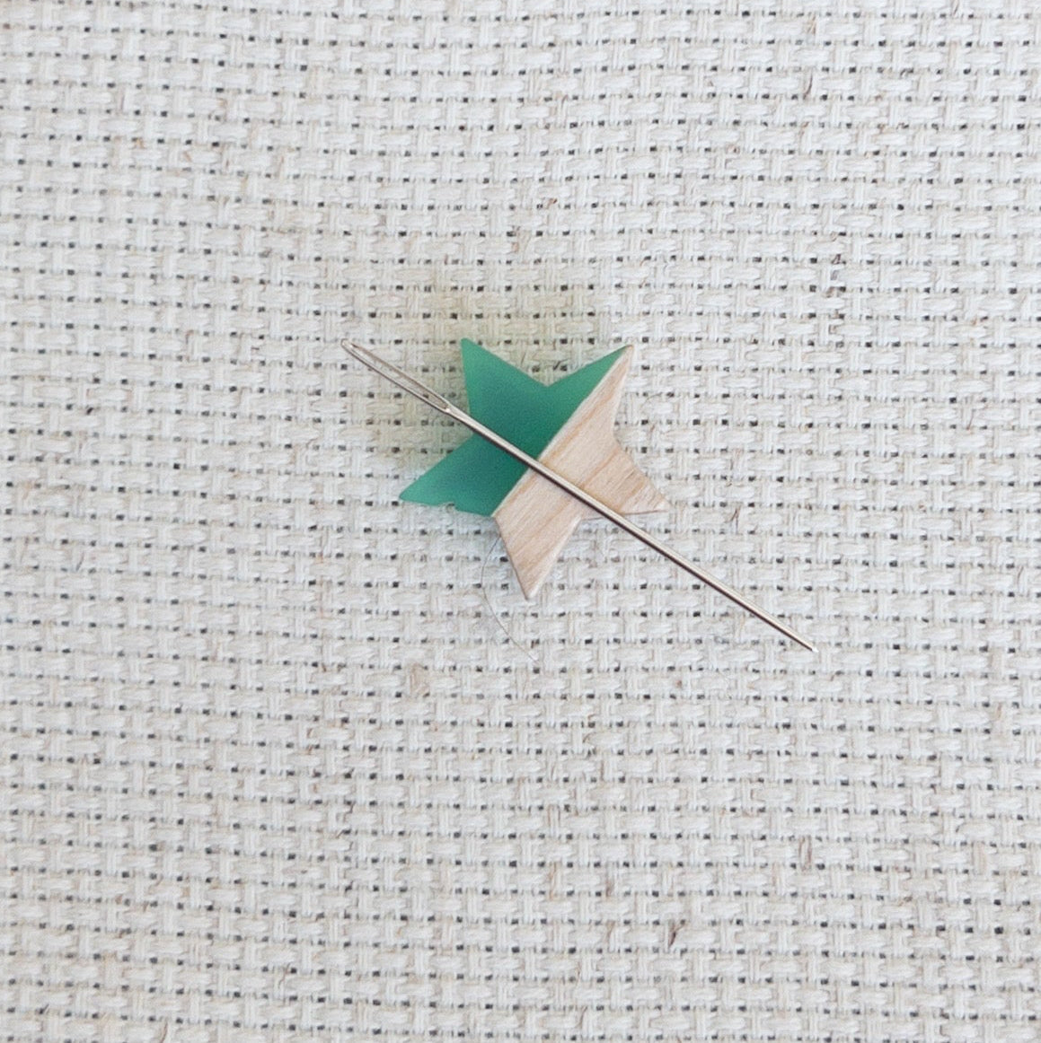 Star shaped magnetic needle minder with green resin and natural wood – ideal for cross stitch, embroidery, needlepoint, quilting, and hand sewing. A unique and functional needle holder for stitchers and crafters.