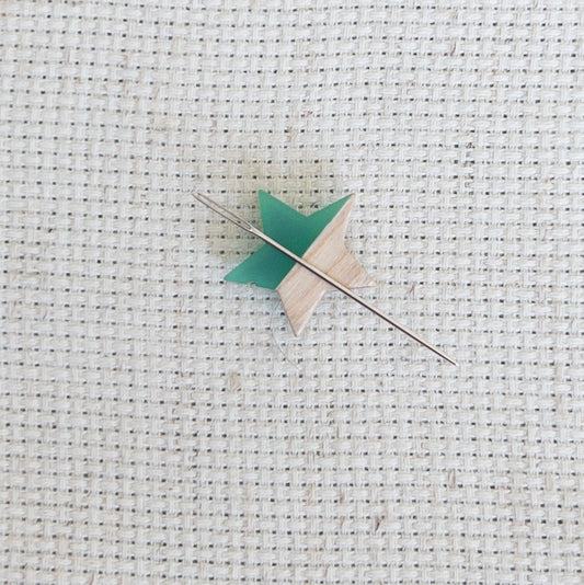 Star shaped magnetic needle minder with green resin and natural wood – ideal for cross stitch, embroidery, needlepoint, quilting, and hand sewing. A unique and functional needle holder for stitchers and crafters.