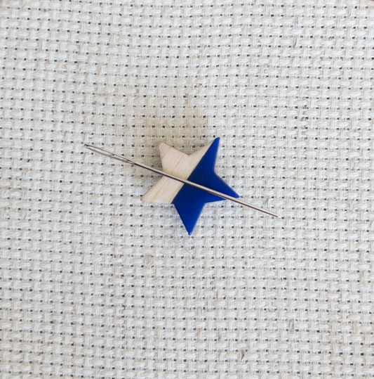 Star shaped magnetic needle minder with blue resin and natural wood – ideal for cross stitch, embroidery, needlepoint, quilting, and hand sewing. A unique and functional needle holder for stitchers and crafters.