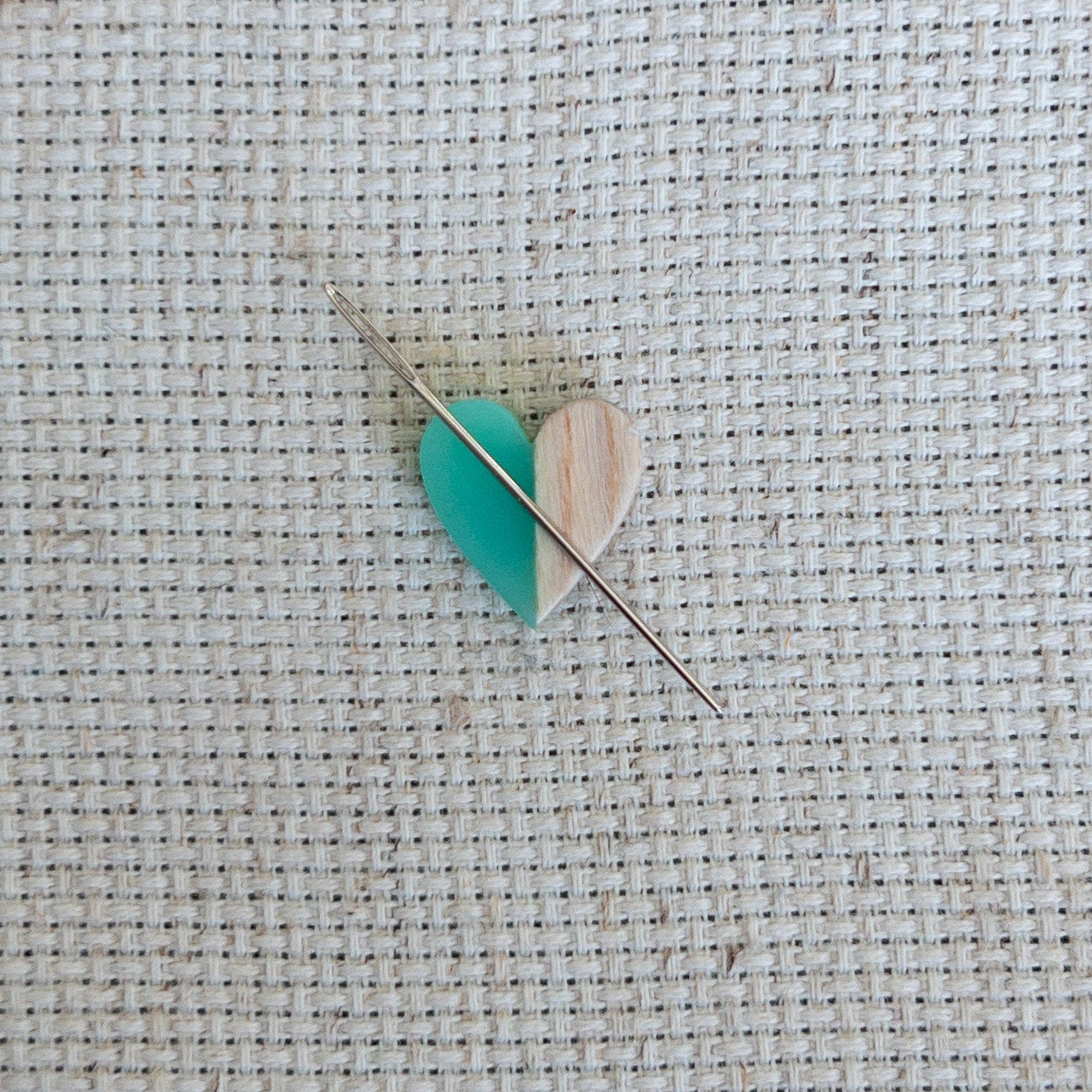 Heart shaped magnetic needle minder with green resin and brown wood – perfect for cross stitch, embroidery, needlepoint, quilting, and hand sewing. A unique and functional needle holder for stitchers and crafters.
