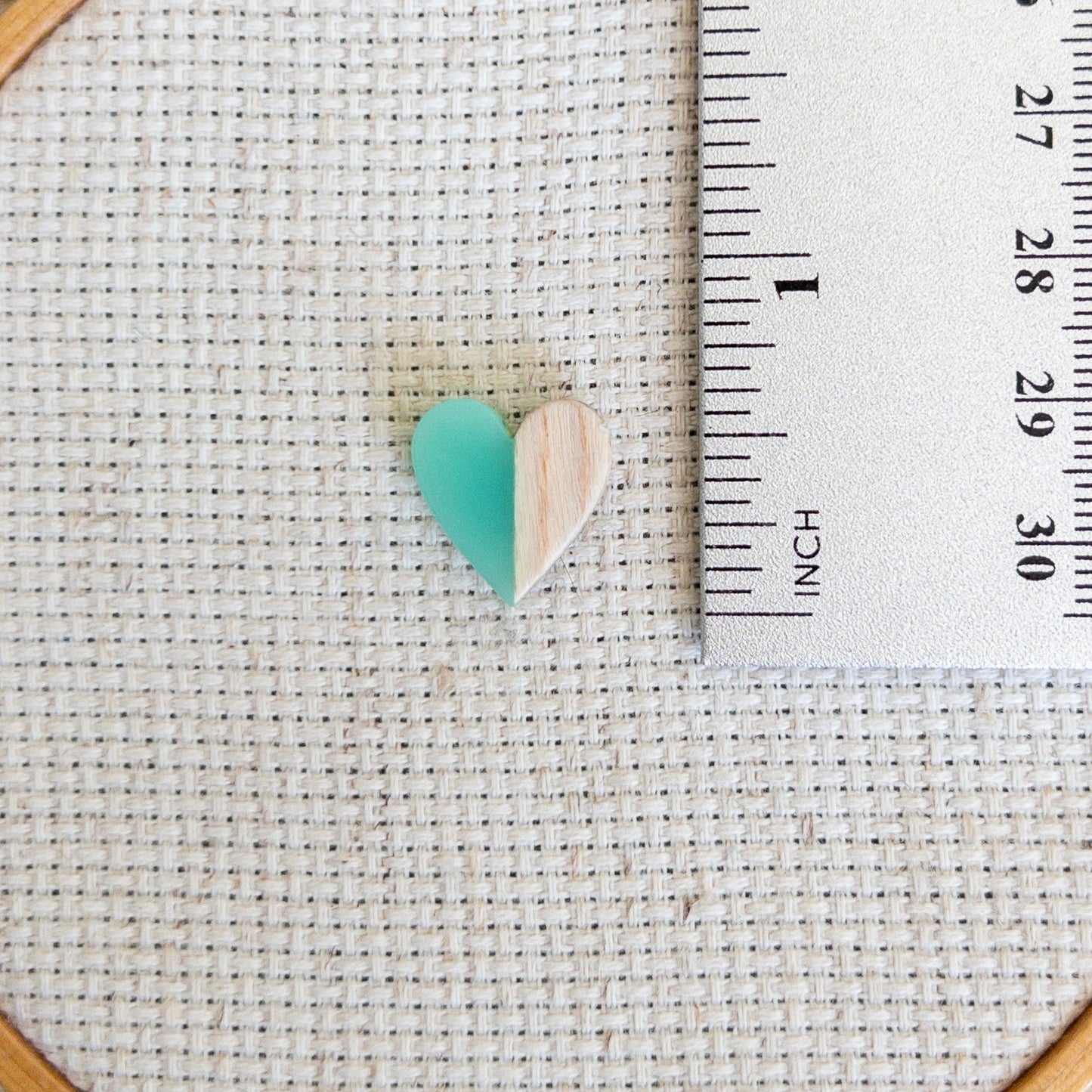 Heart shaped magnetic needle minder with green resin and brown wood – perfect for cross stitch, embroidery, needlepoint, quilting, and hand sewing. A unique and functional needle holder for stitchers and crafters.