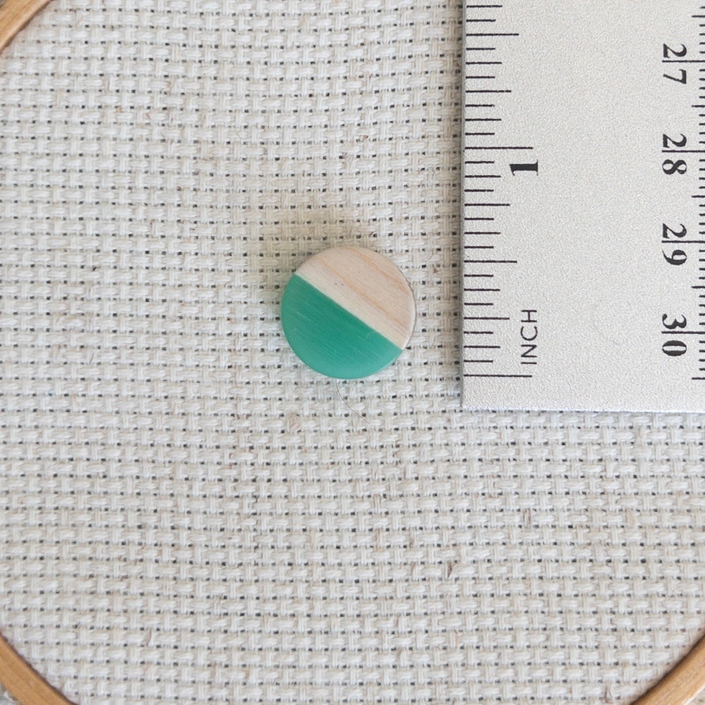 Circle shaped magnetic needle minder with green resin and natural wood – perfect for cross stitch, embroidery, needlepoint, quilting, and hand sewing. A unique and functional needle holder for stitchers and crafters.