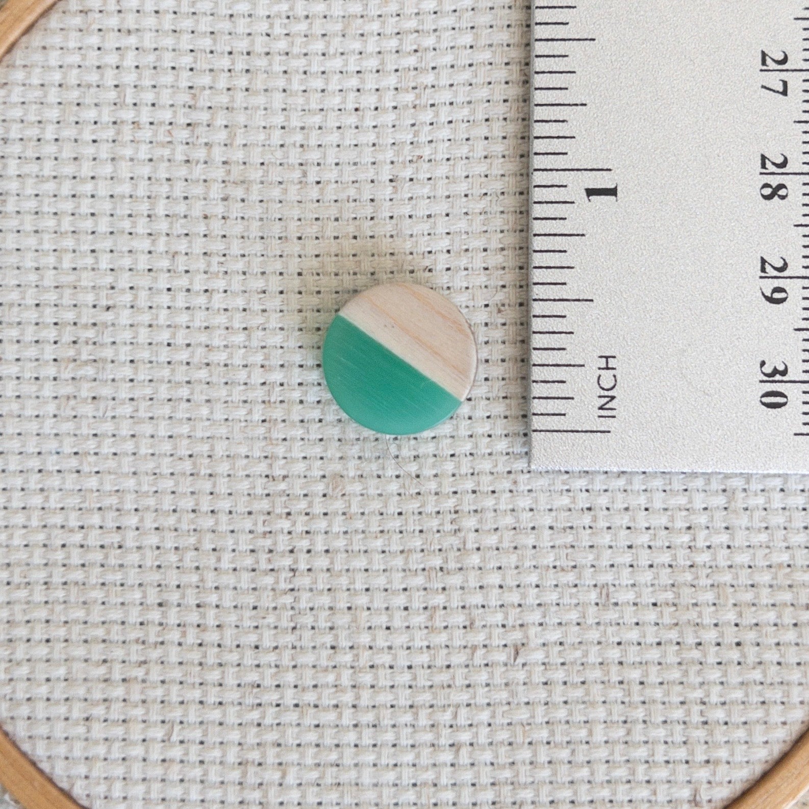 Circle shaped magnetic needle minder with green resin and natural wood – perfect for cross stitch, embroidery, needlepoint, quilting, and hand sewing. A unique and functional needle holder for stitchers and crafters.